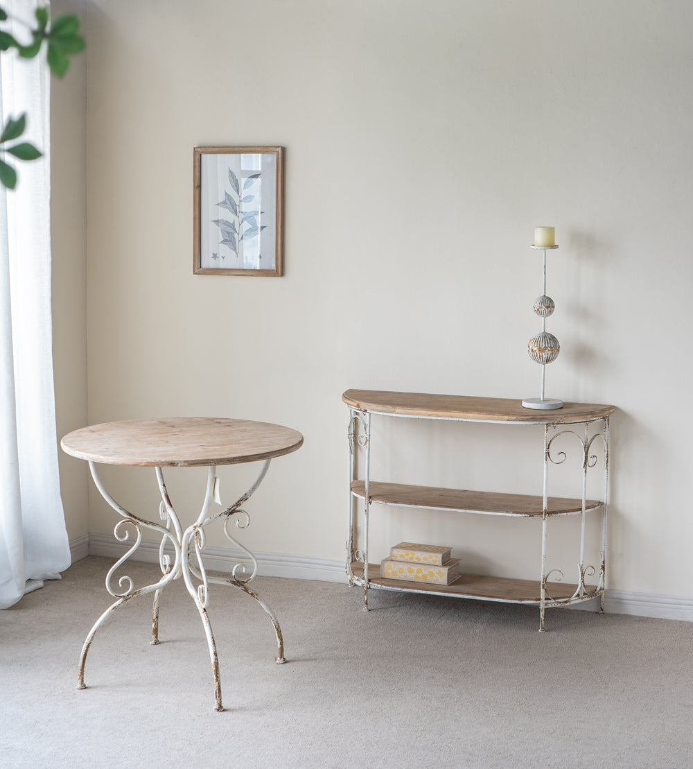 Distressed white metal bistro table with a light wood round top