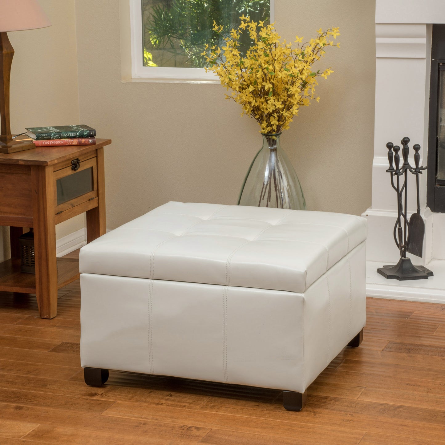 White tufted leather storage ottoman with dark wood legs