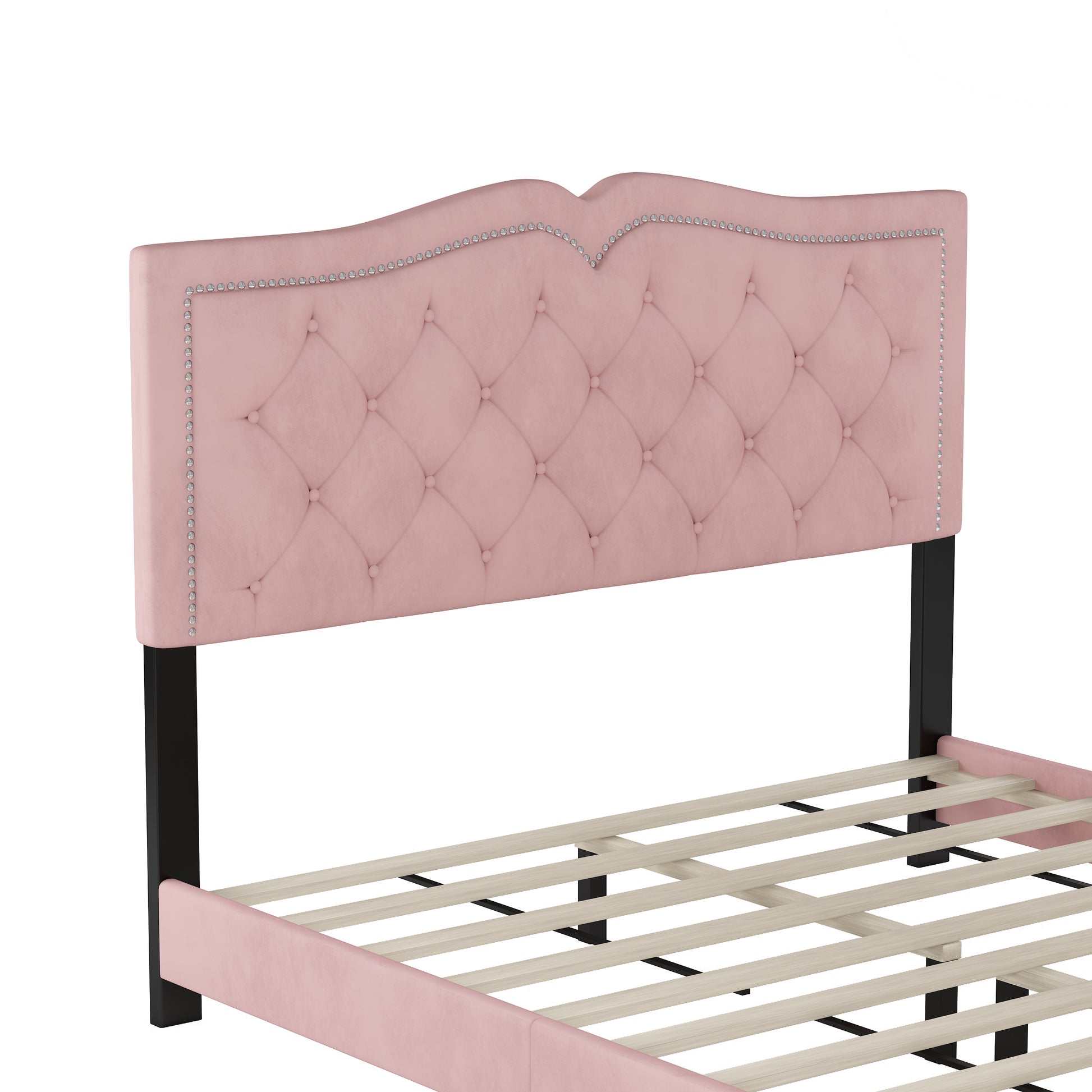 Pink velvet tufted headboard with nailhead trim on bed frame