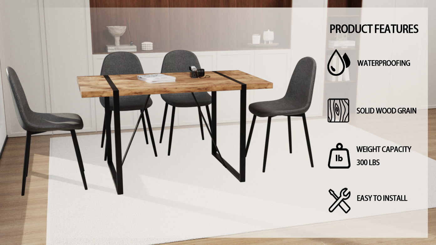 Rustic wood dining table with black metal legs and four grey upholstered chairs