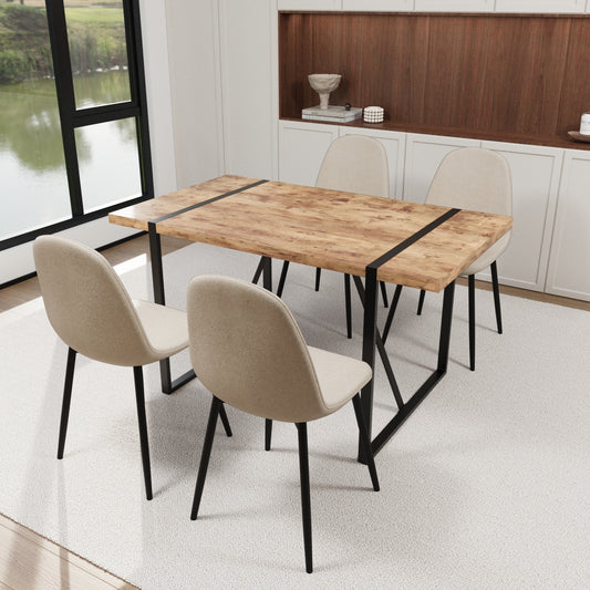 Rustic wood dining table with black metal legs and four beige fabric chairs