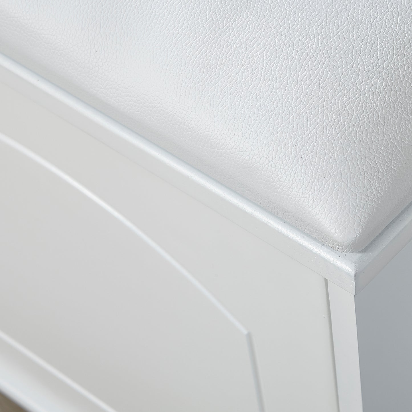 White faux leather upholstered storage ottoman with hinged lid