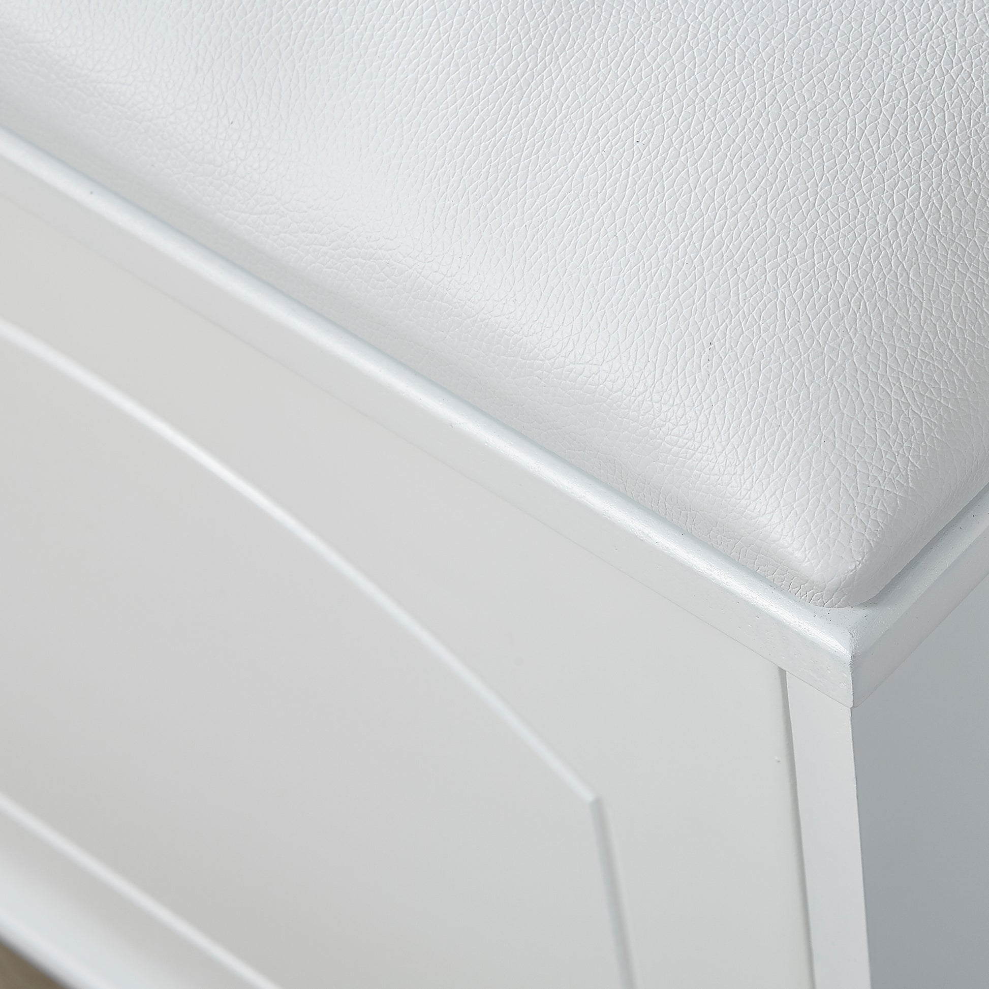 White faux leather upholstered storage ottoman with hinged lid
