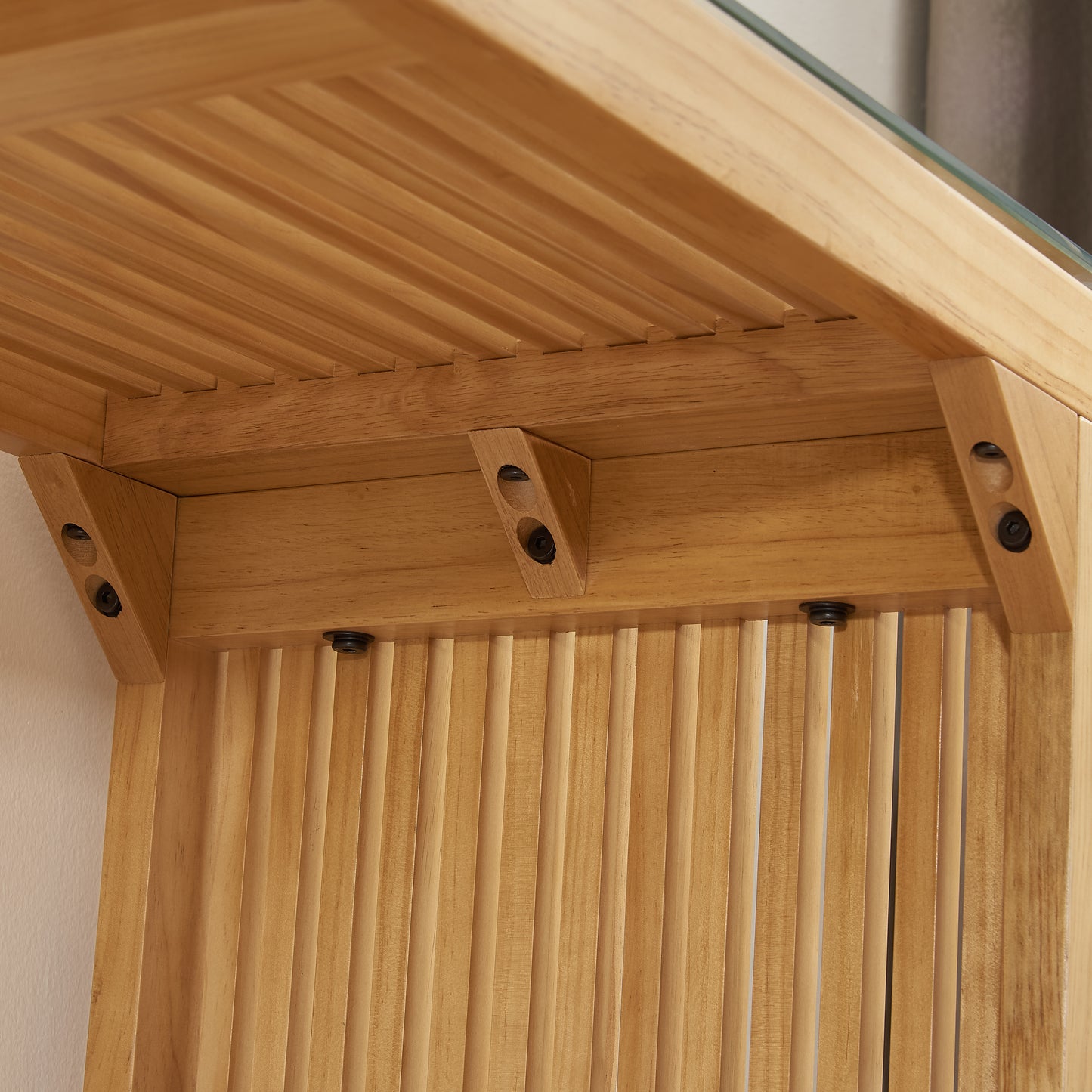 Natural light wood furniture with slatted panel detail