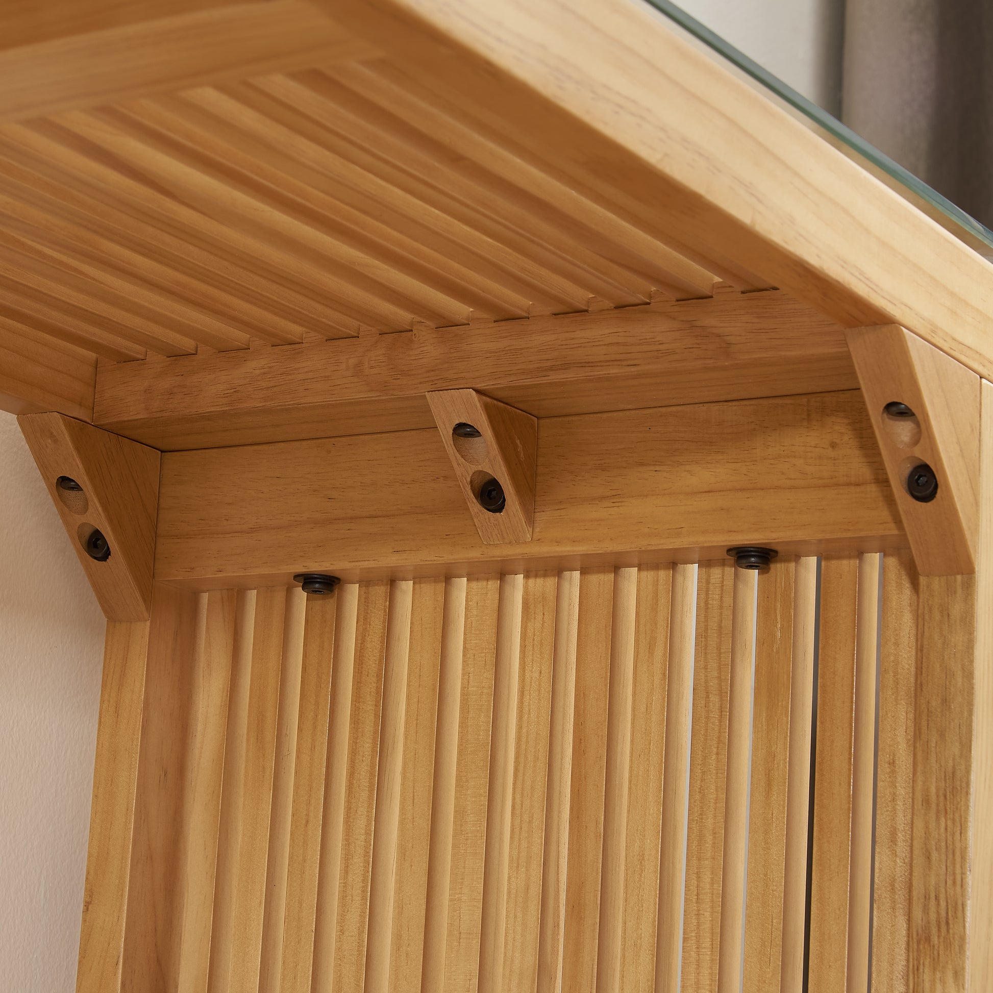 Natural light wood furniture with slatted panel detail