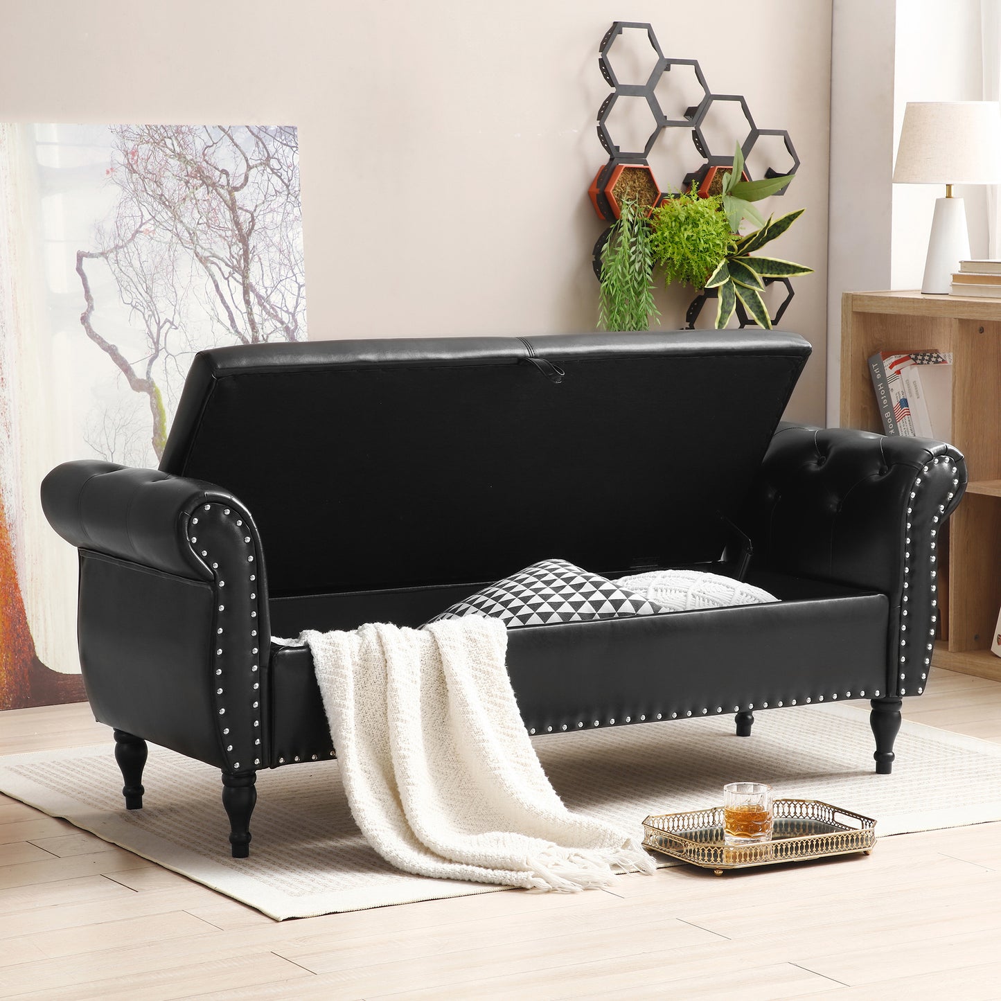 Black leather storage bench with tufted details and silver nailhead trim