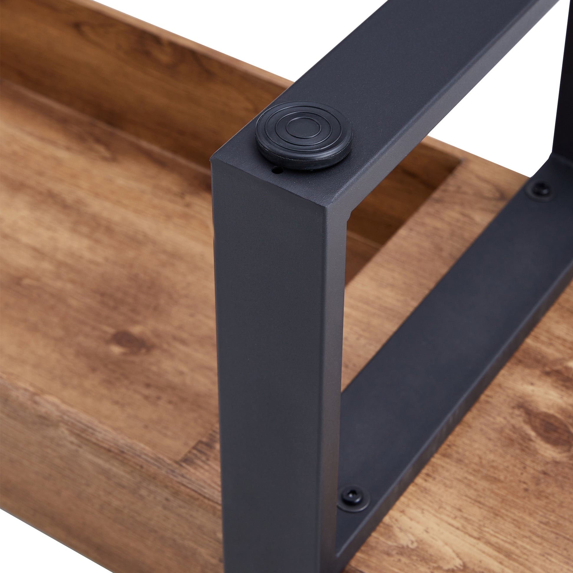 Closeup of rustic wood grain shelf with a matte black metal support leg