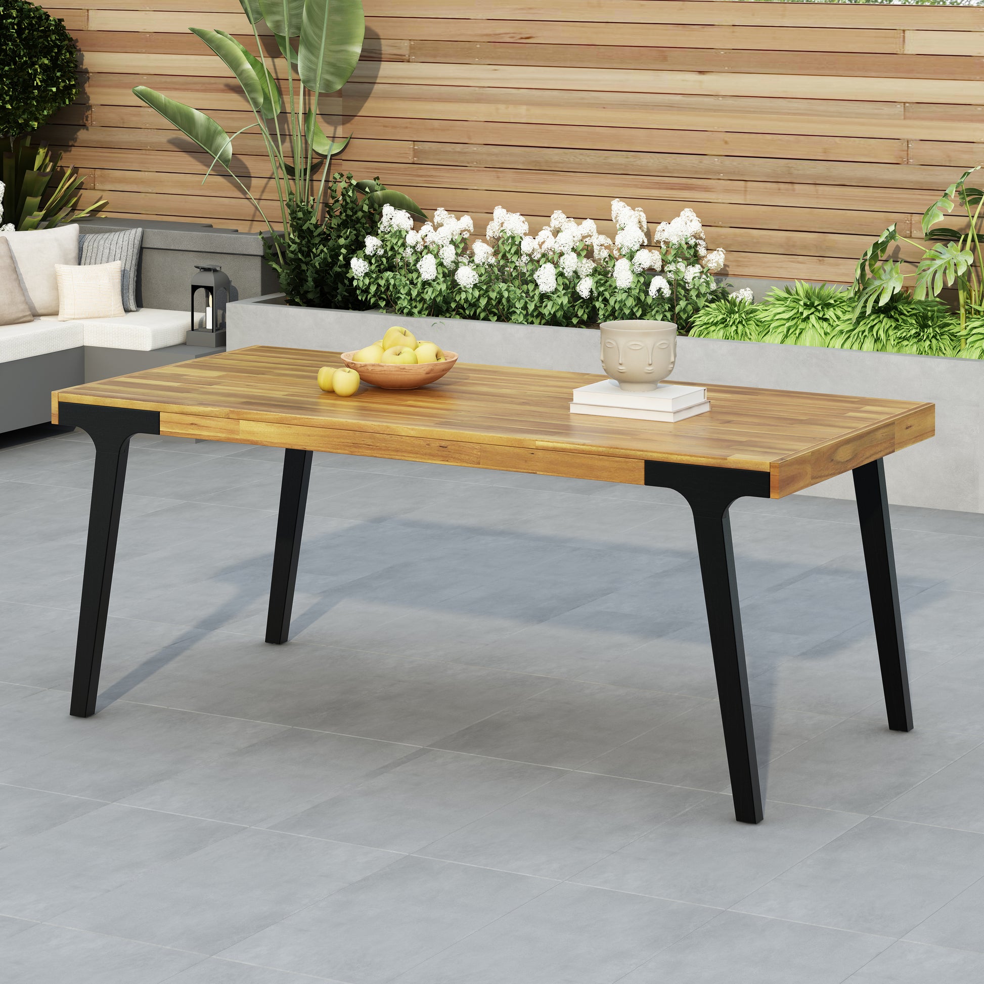 Wooden outdoor dining table with sleek black legs perfect for patio gatherings