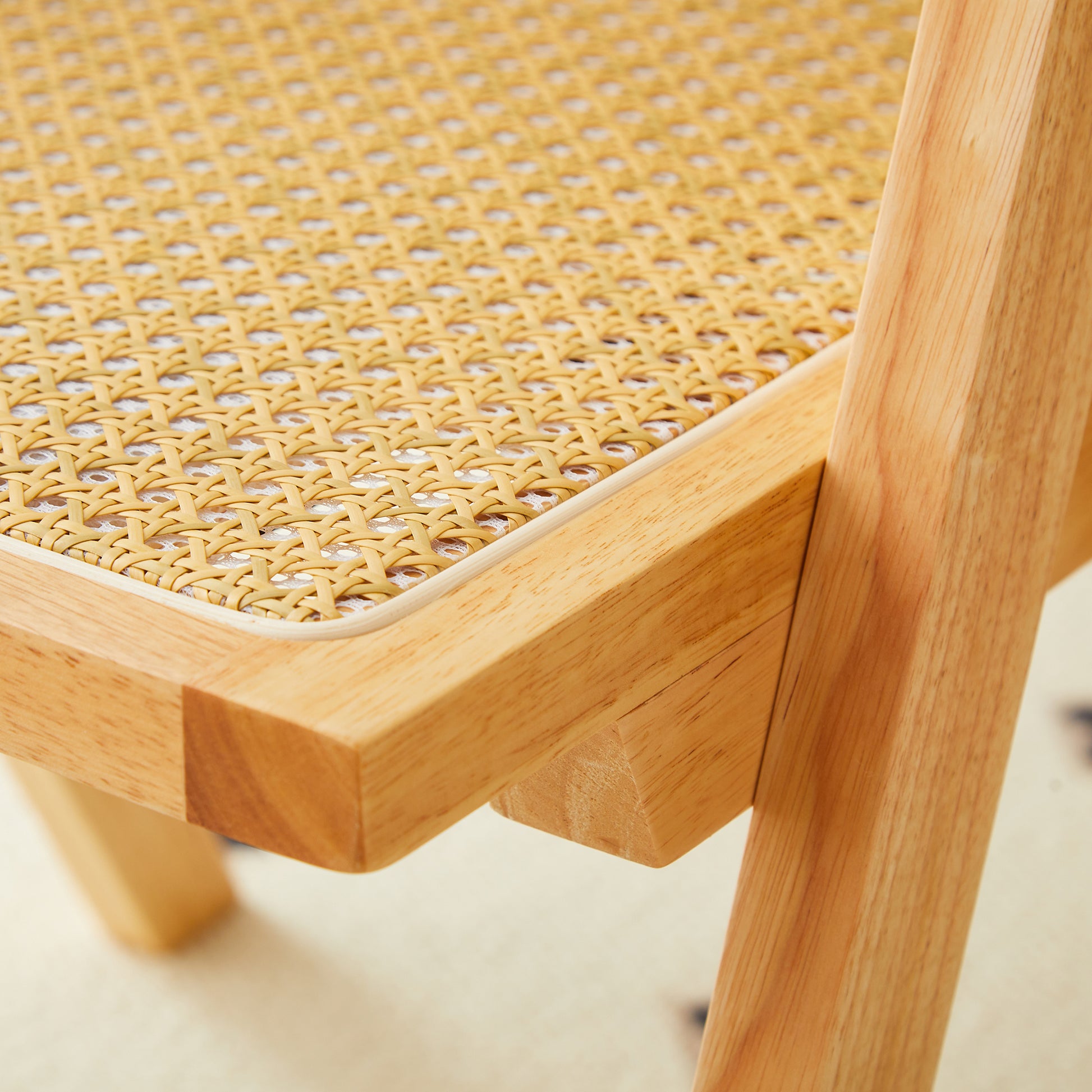 Natural wood chair frame with detailed woven cane seat texture