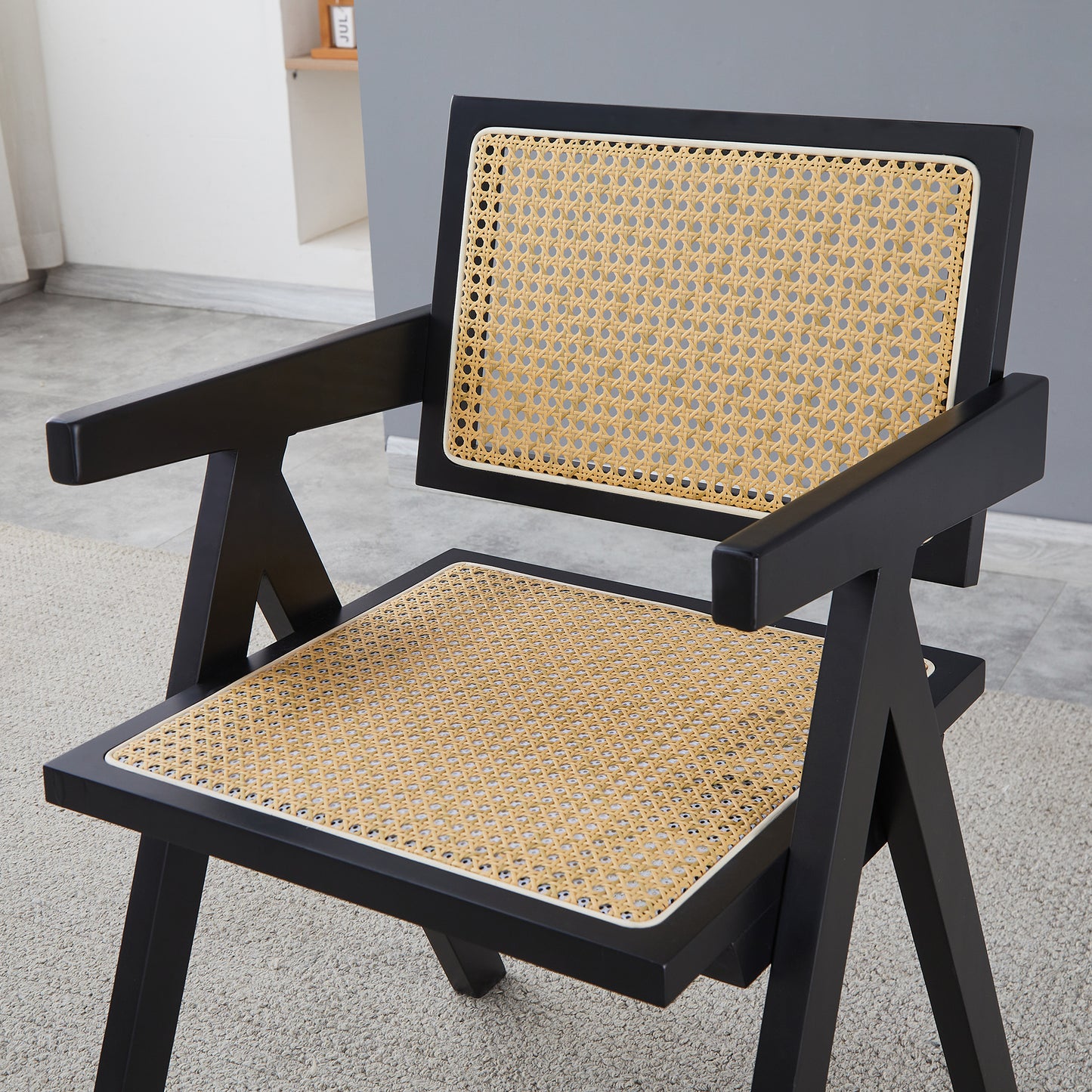 Black wood armchair with cane seat and back