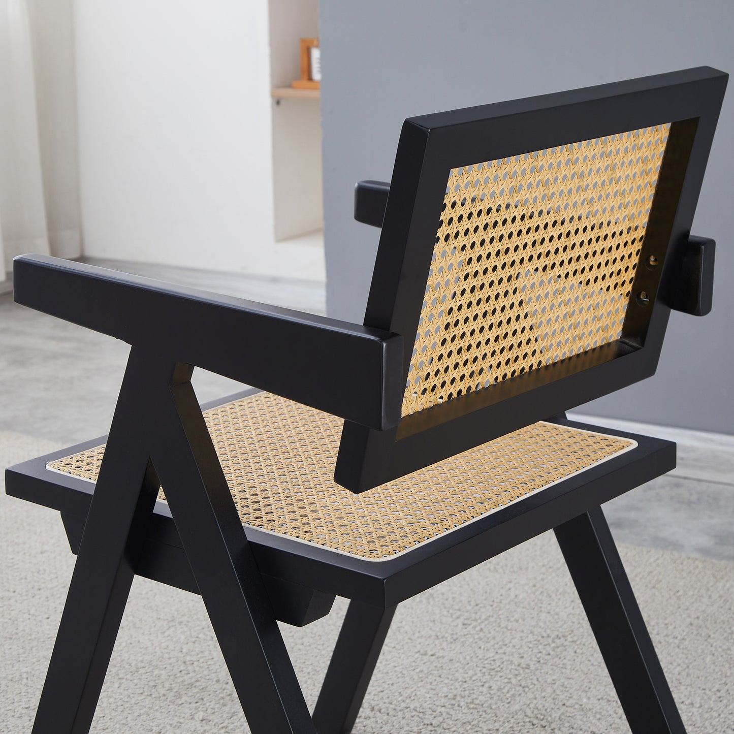 Black rattan accent chair with geometric frame