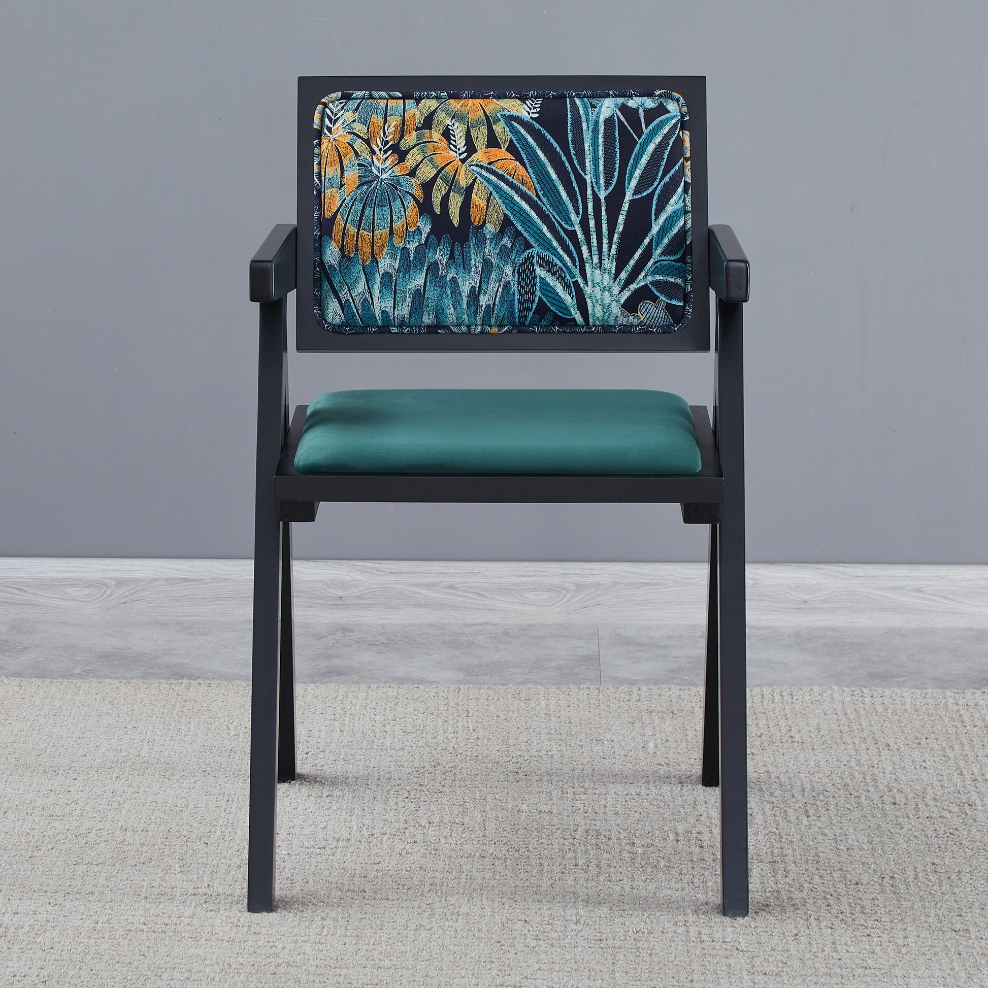 Dark grey accent chair with botanical print upholstery and teal velvet seat