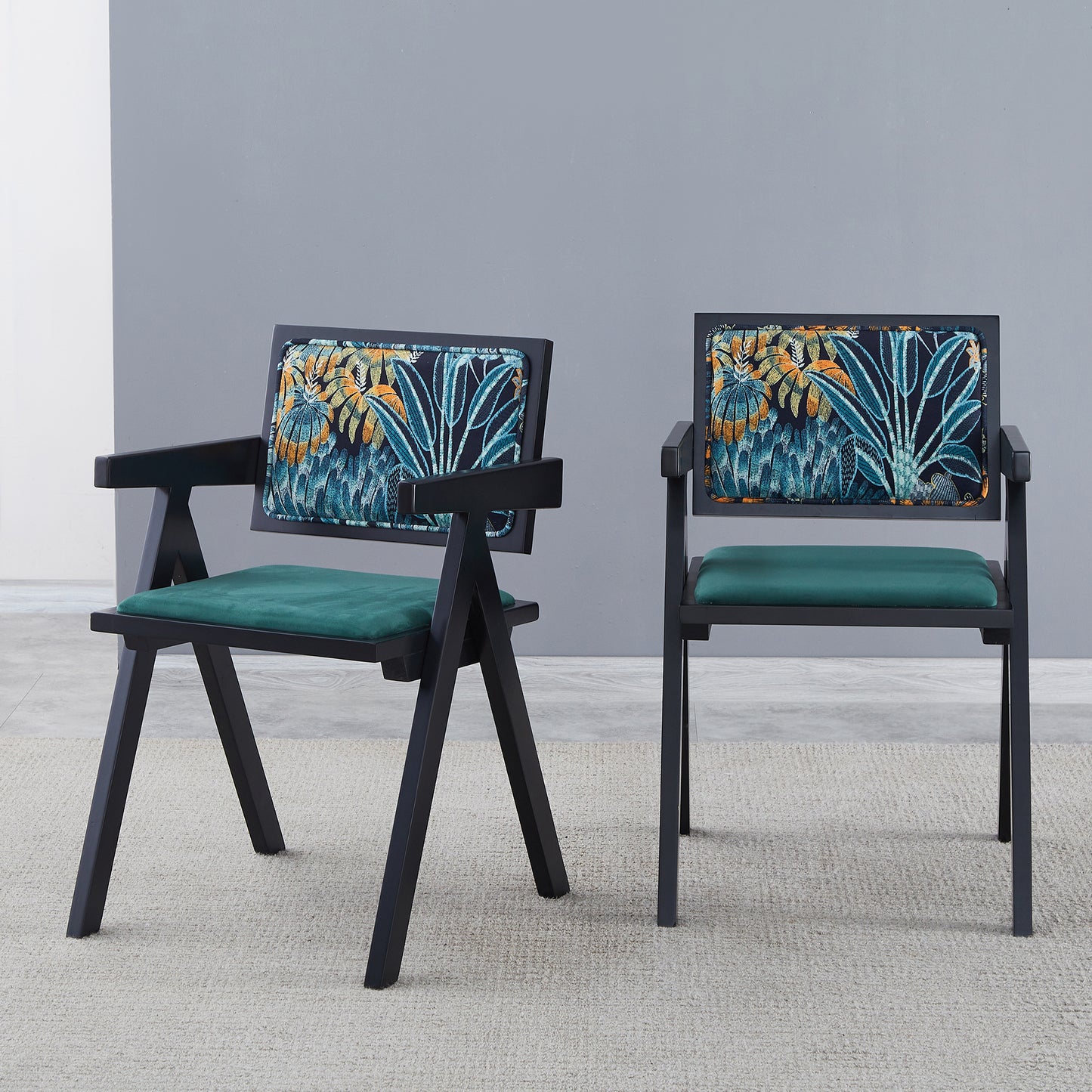 Black wooden accent chair with green seat and tropical leaf patterned backrest