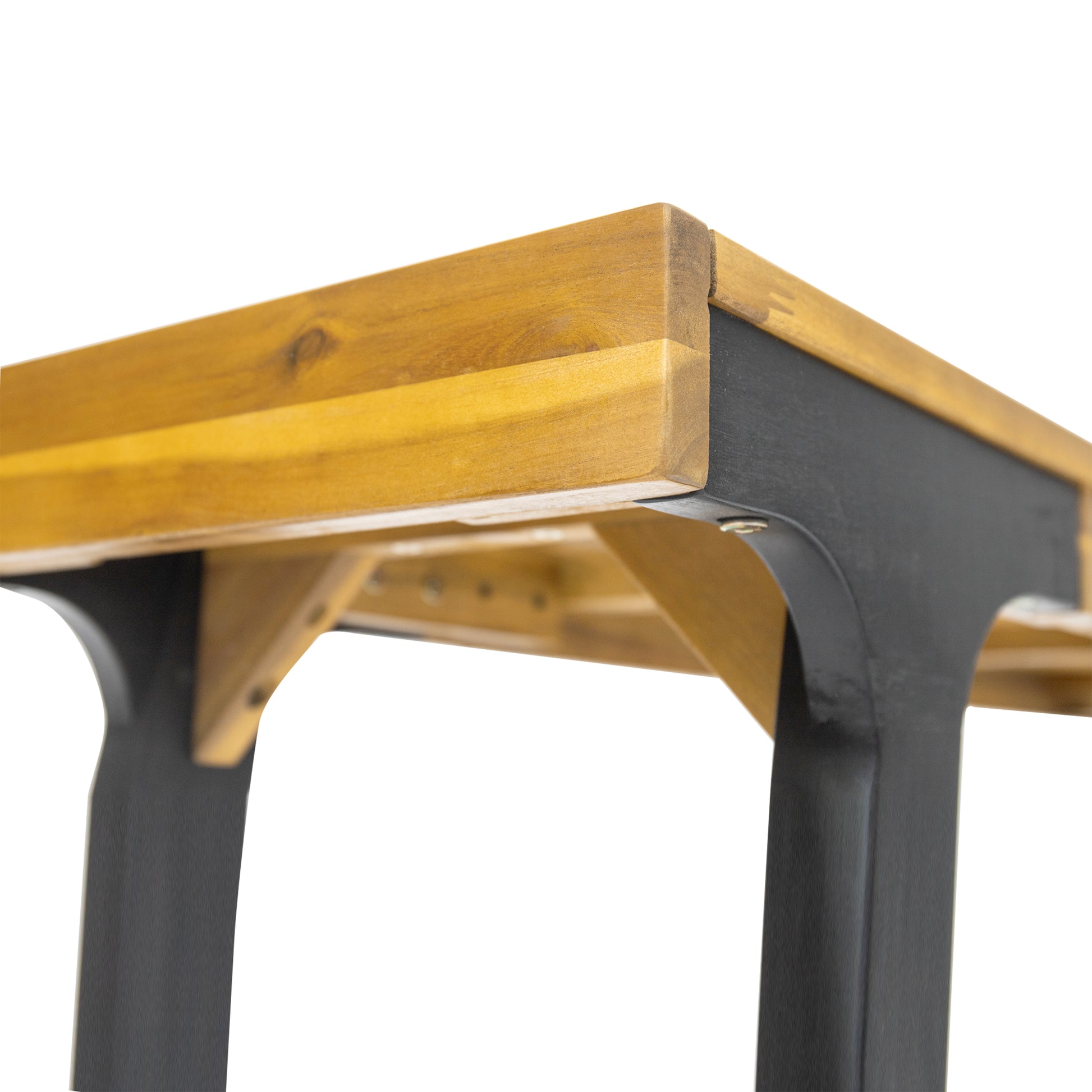 Closeup of a wooden dining table with dark grey metal legs
