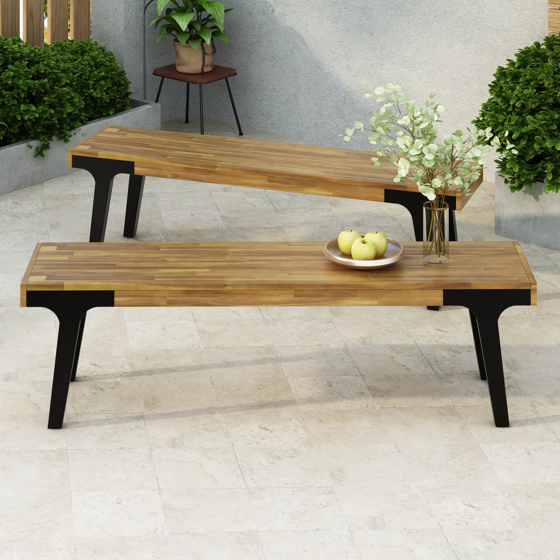 Acacia wood outdoor bench with black metal legs and a contemporary design
