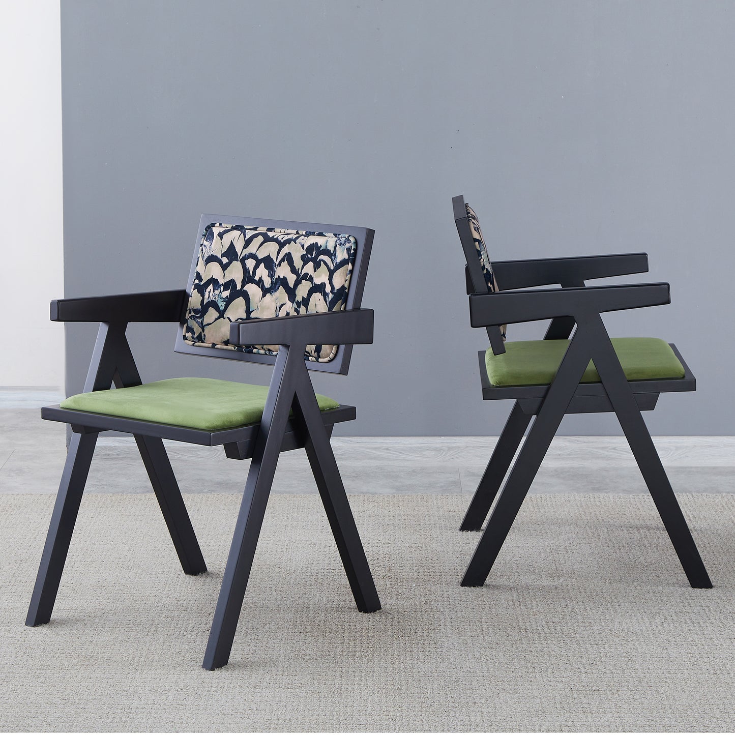 Modern black wooden armchair with green velvet seat and patterned backrest