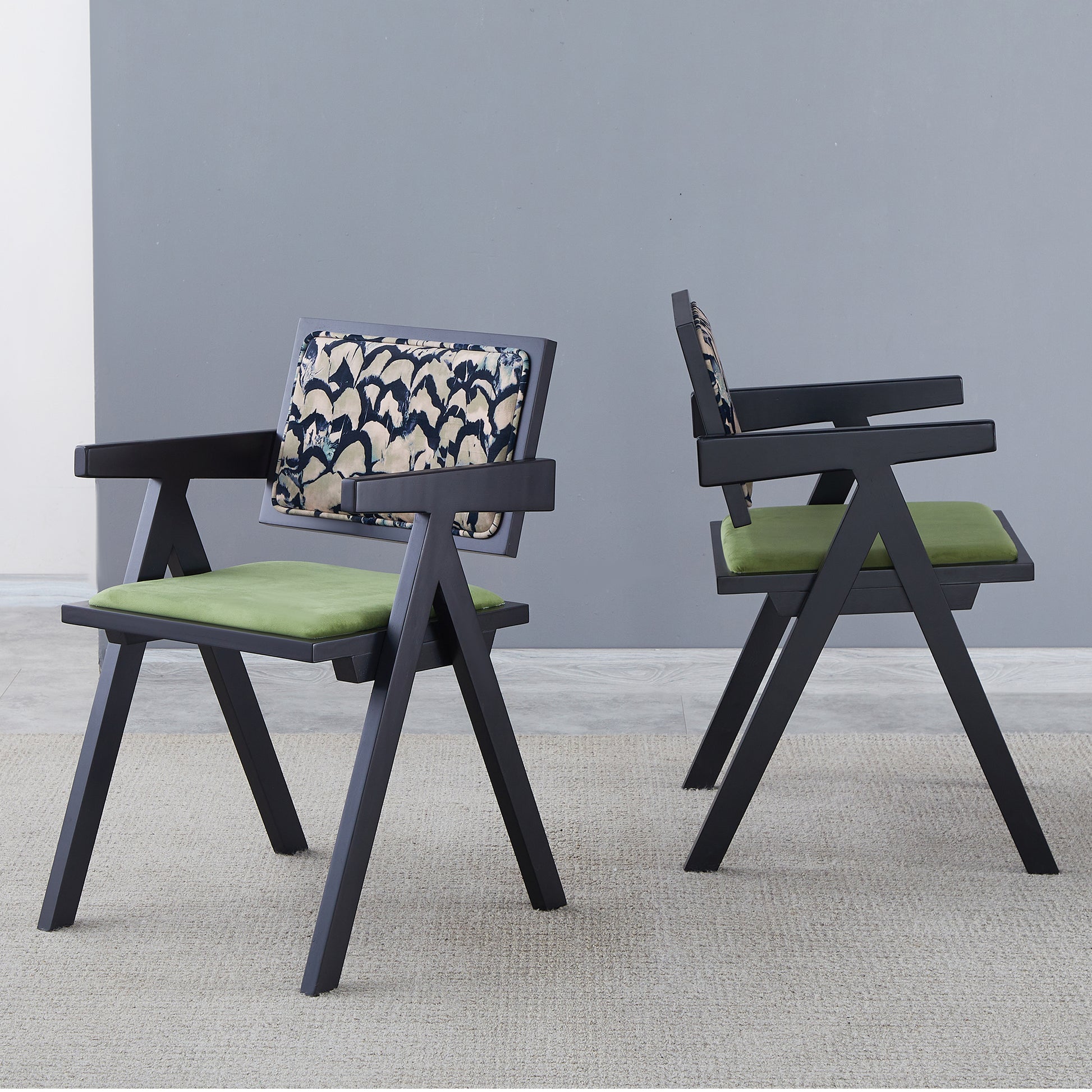 Modern black wooden armchair with green velvet seat and patterned backrest
