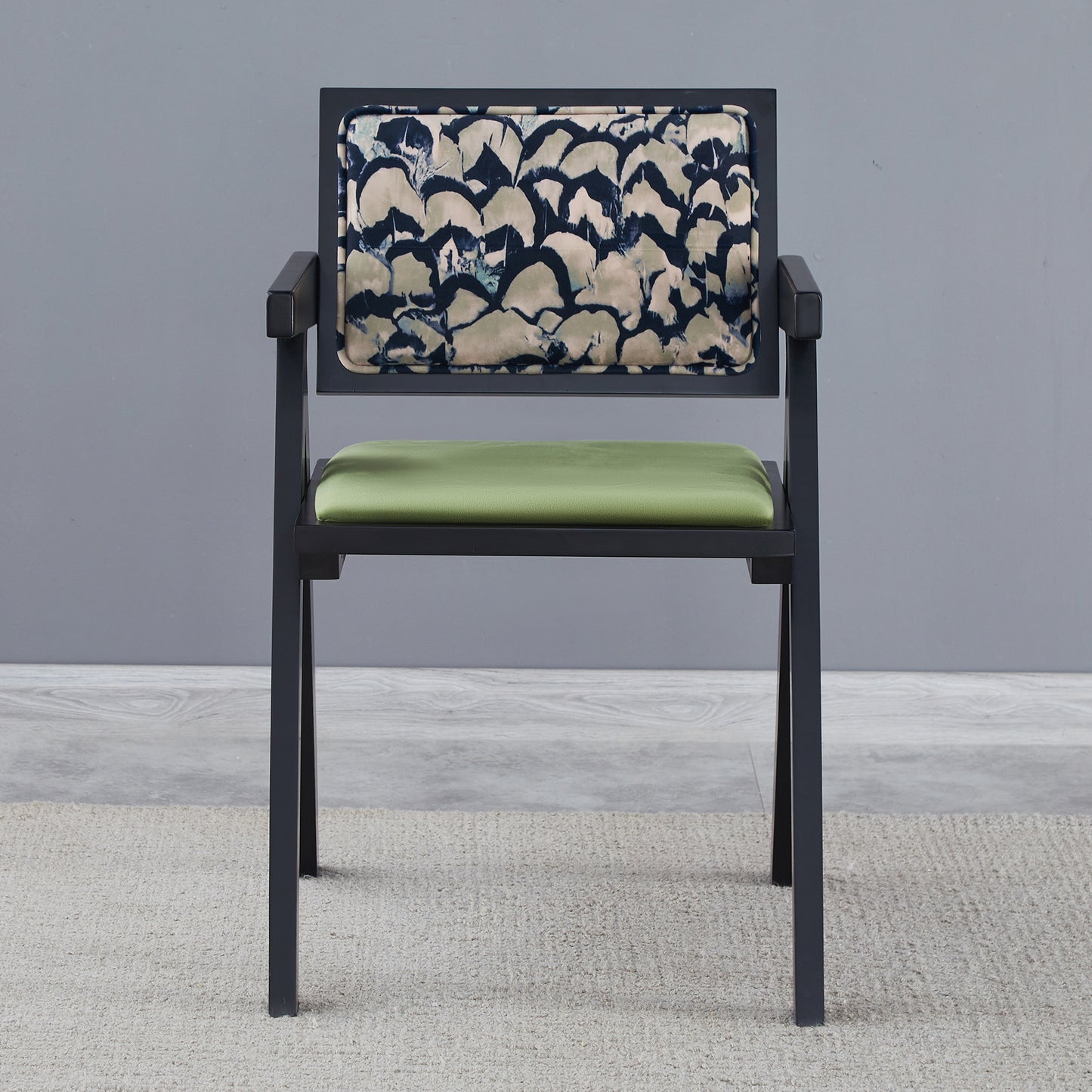 Modern arm chair with abstract patterned backrest and green velvet seat