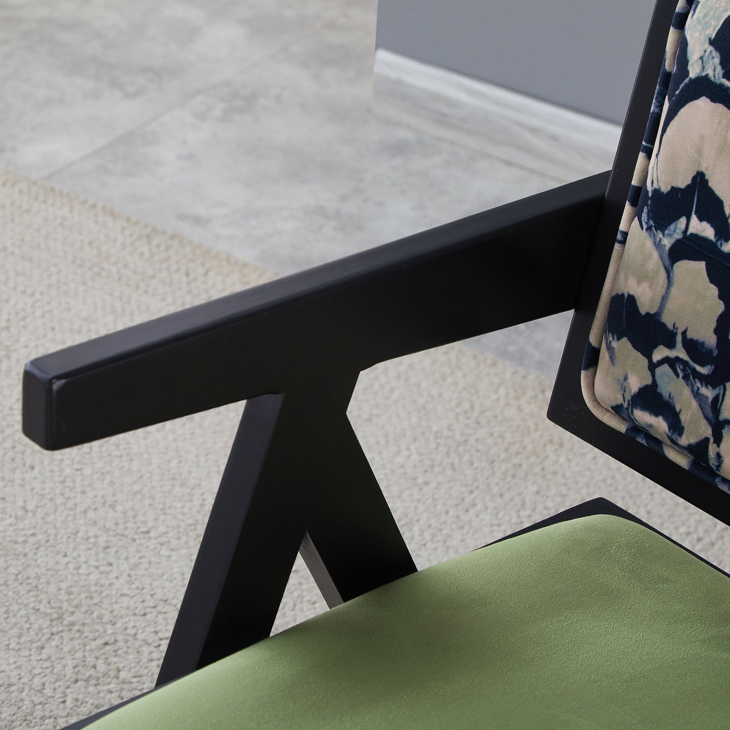 Black wood armchair with olive green seat and abstract patterned backrest