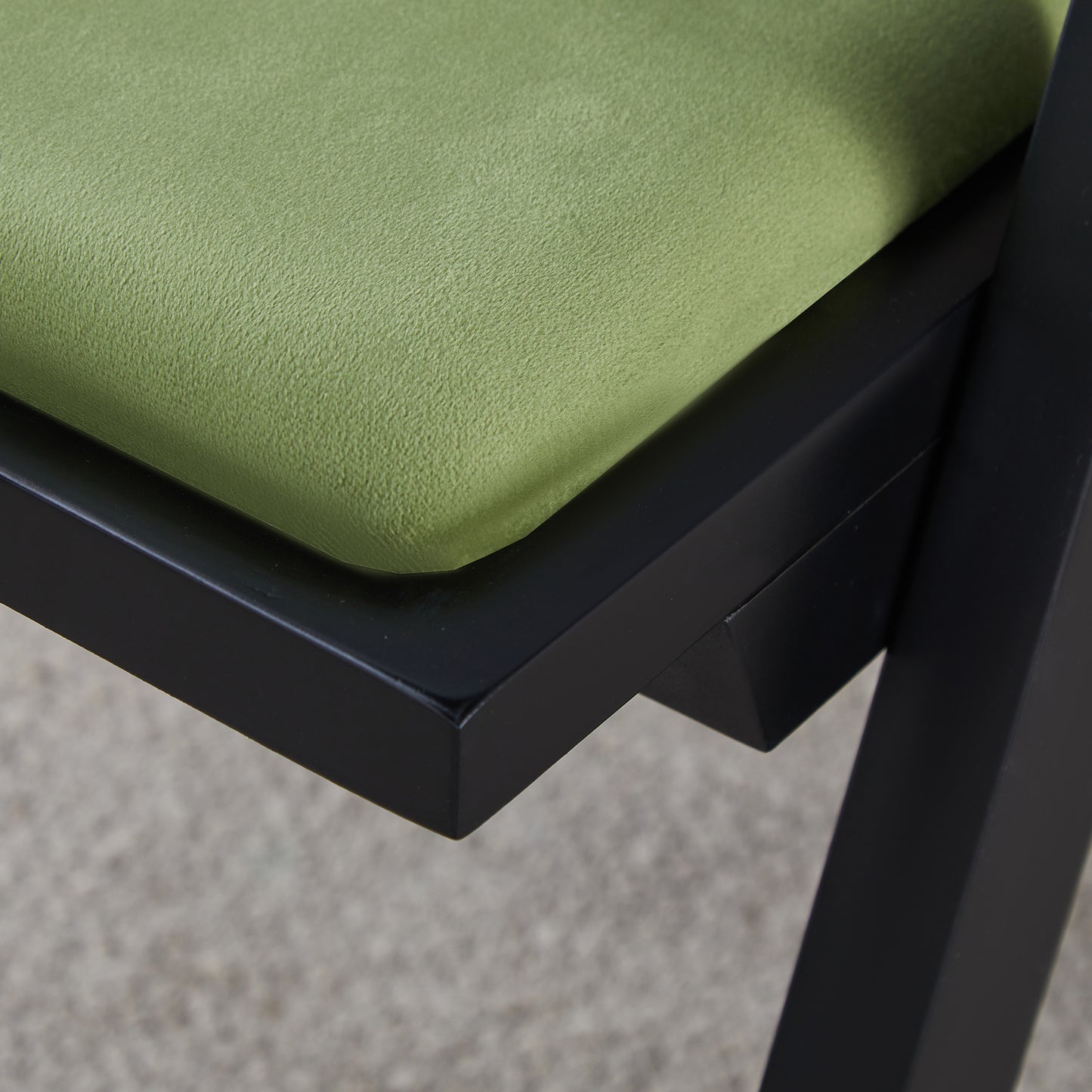 Close up of a textured sage green upholstered chair seat cushion