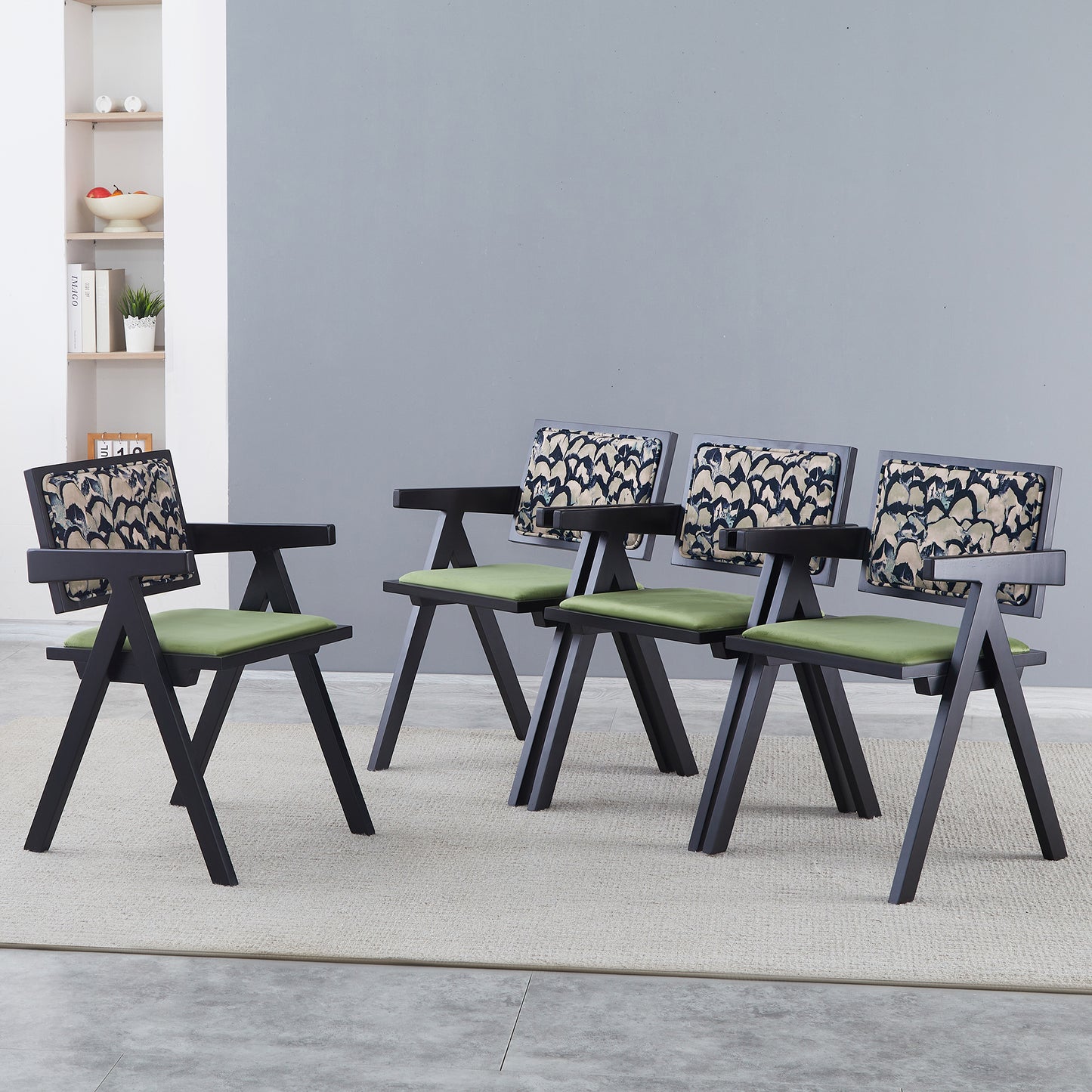 Four modern black armchairs with green seats and abstract patterned backrests