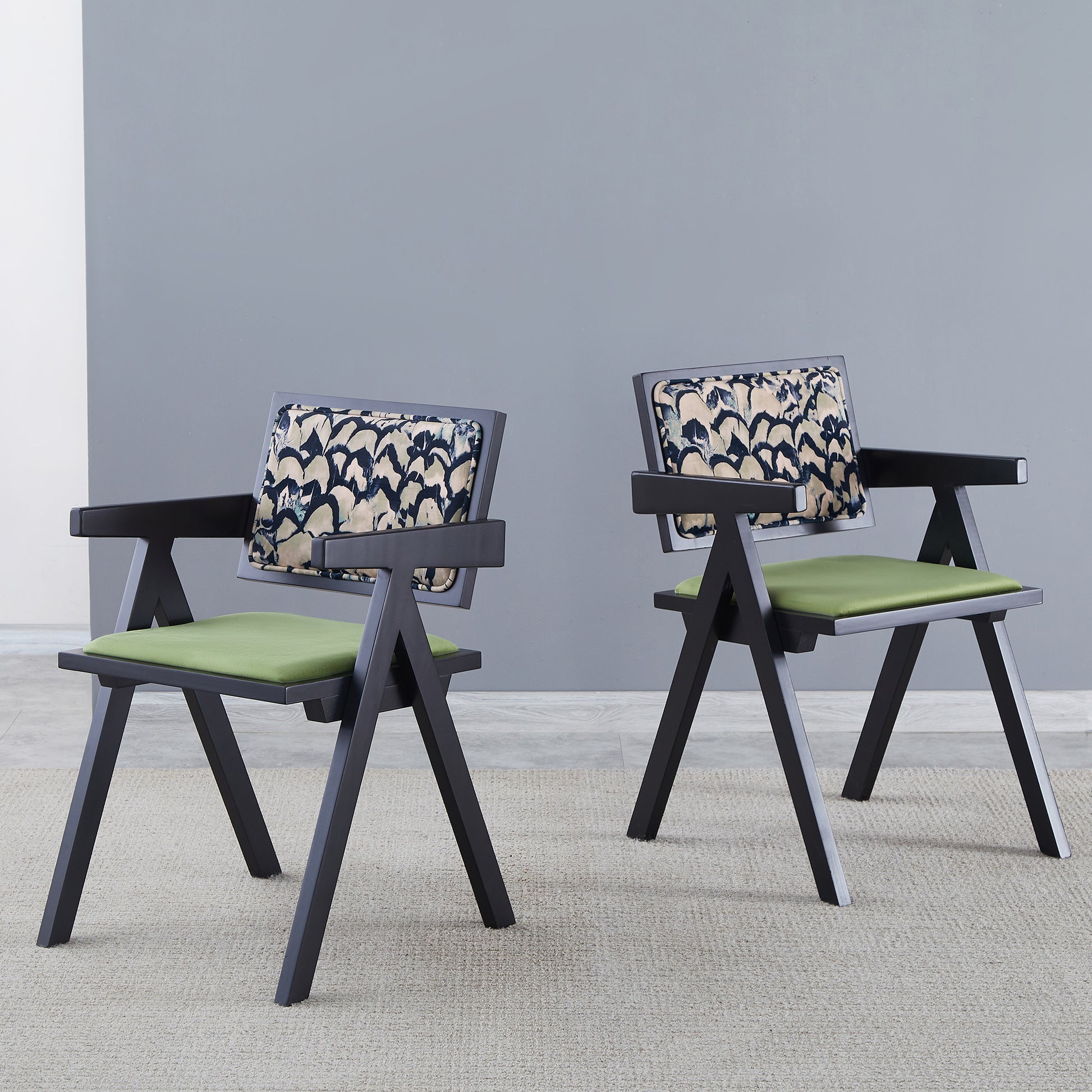 Modern accent chair with black frame and patterned back cushion