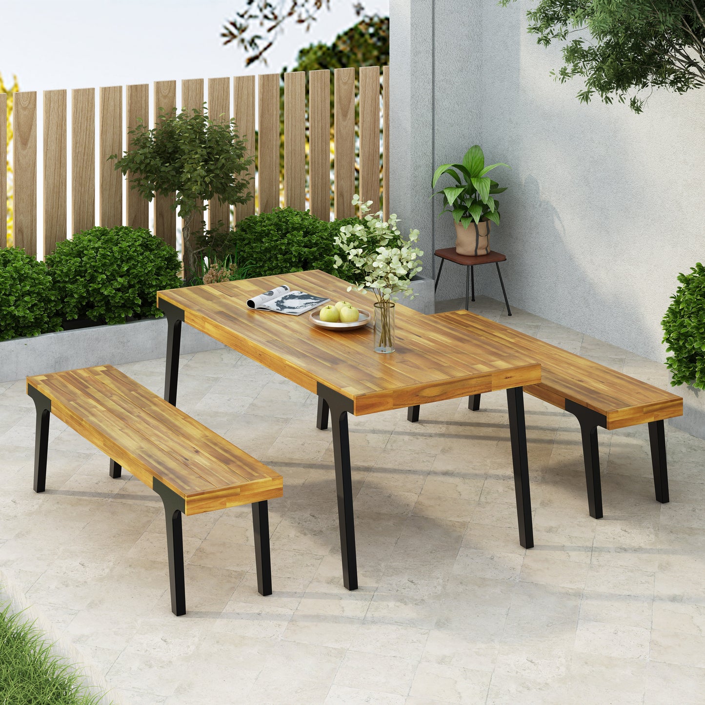 Acacia wood dining set with black metal legs on patio