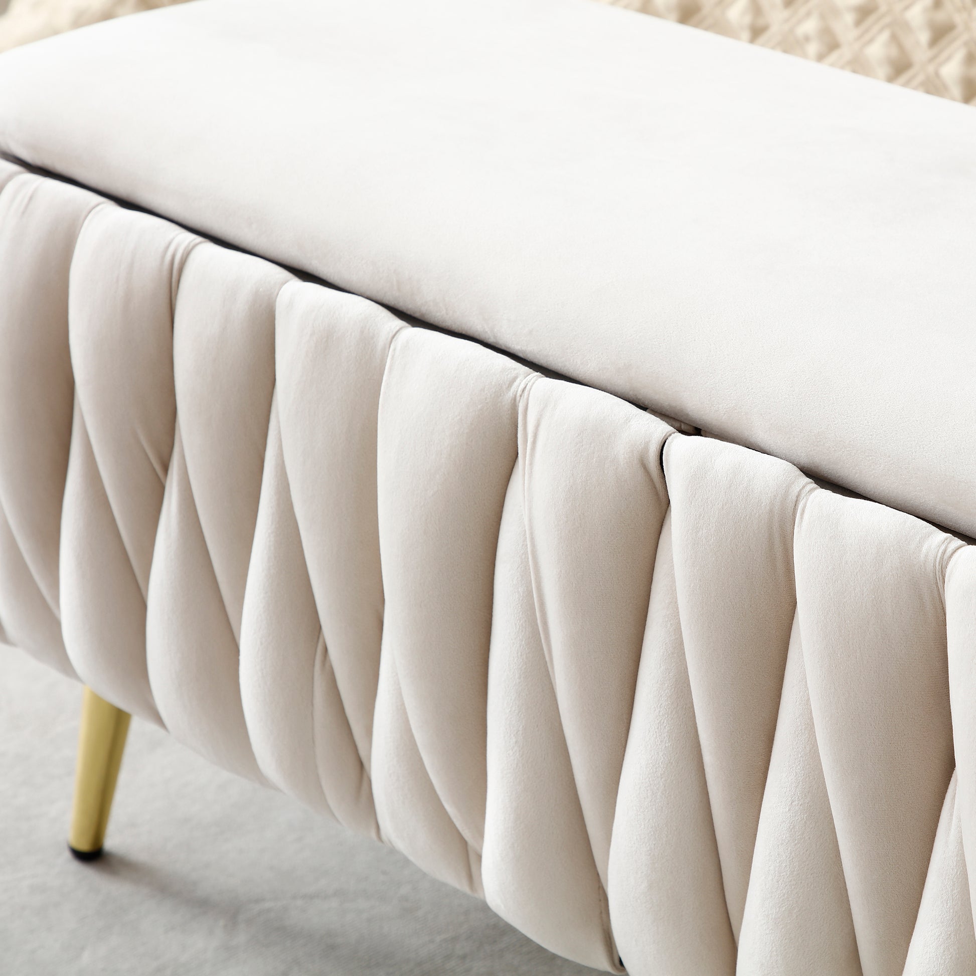 Cream velvet storage ottoman with gold legs and tufted side detail