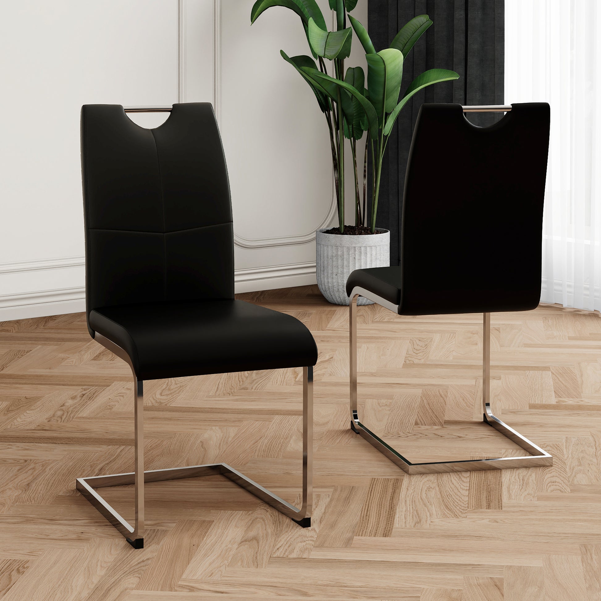 Black faux leather dining chair with chrome sled base