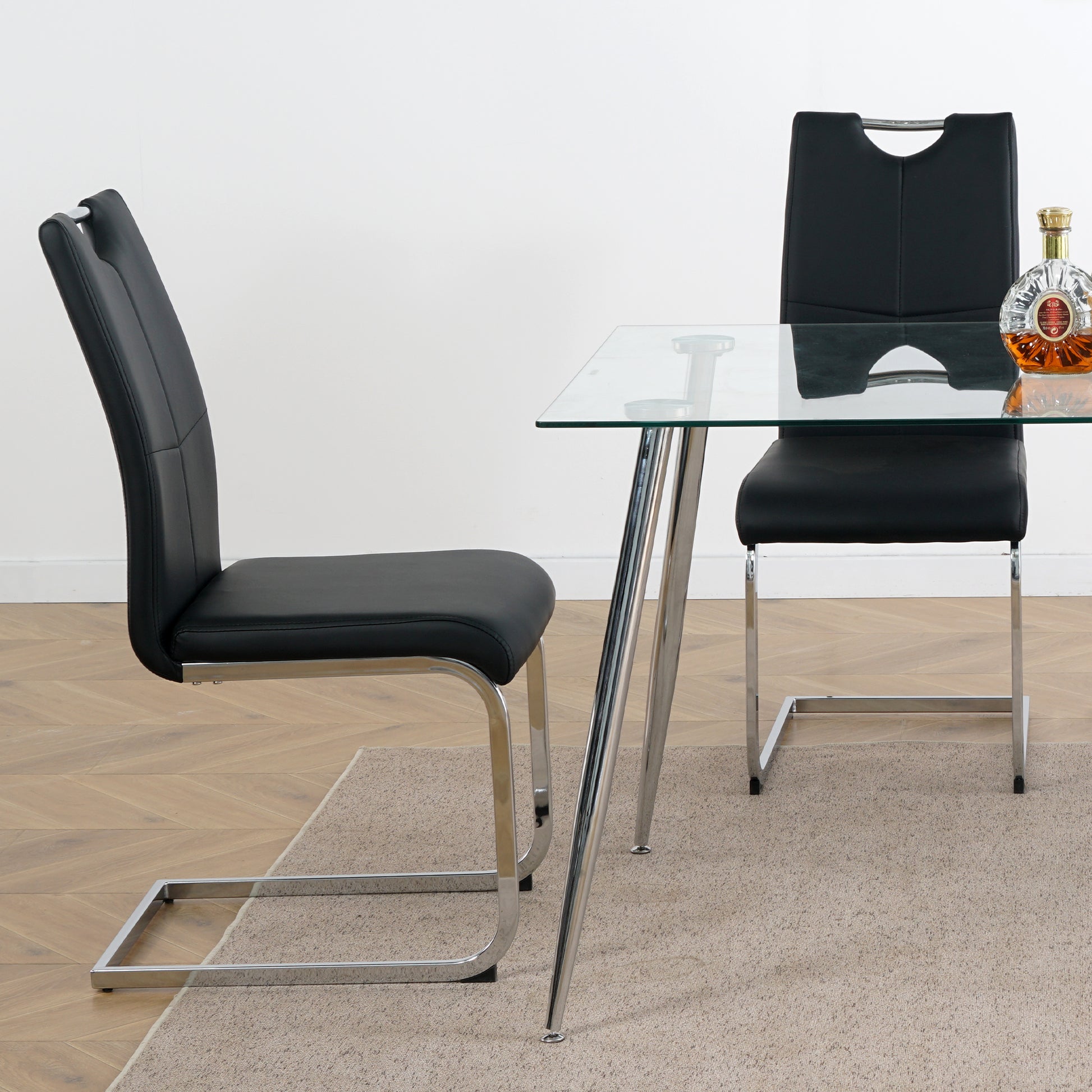 Black faux leather dining chair with chrome cantilever legs