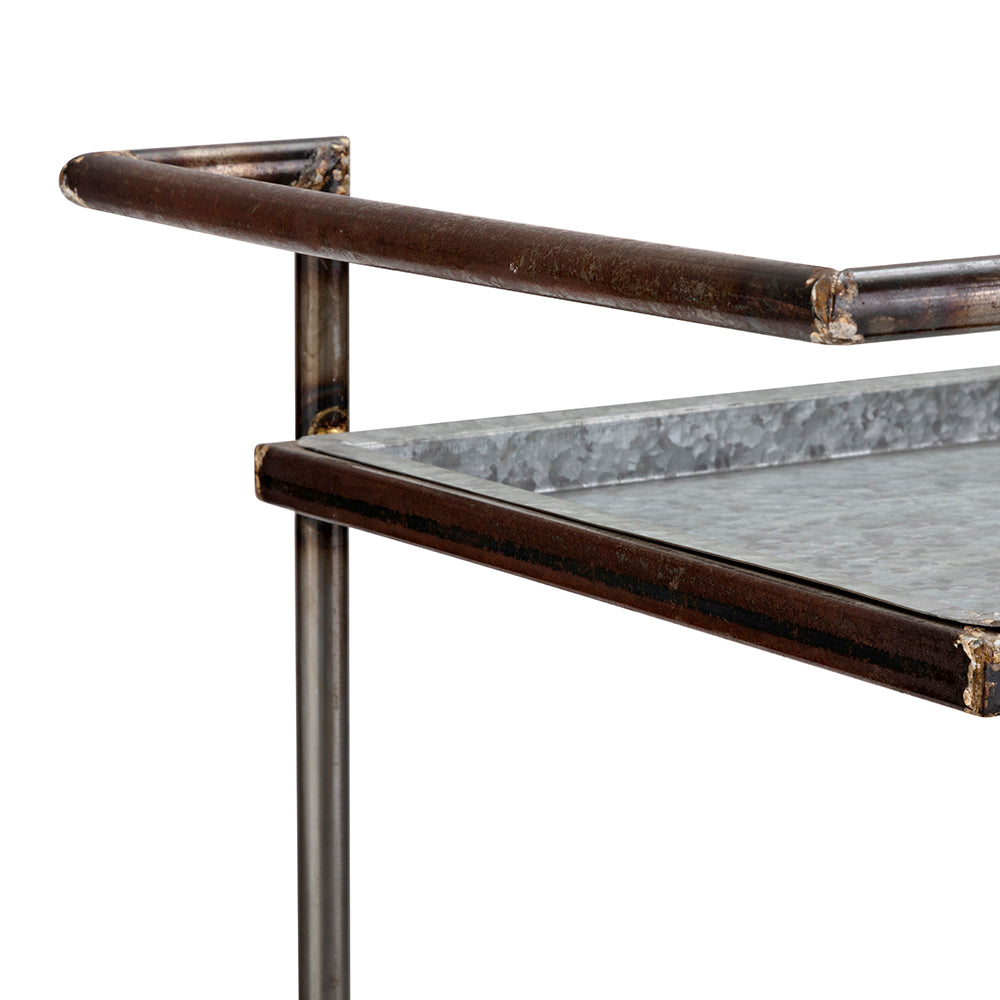 Closeup of industrial metal bar cart with galvanized tray shelf