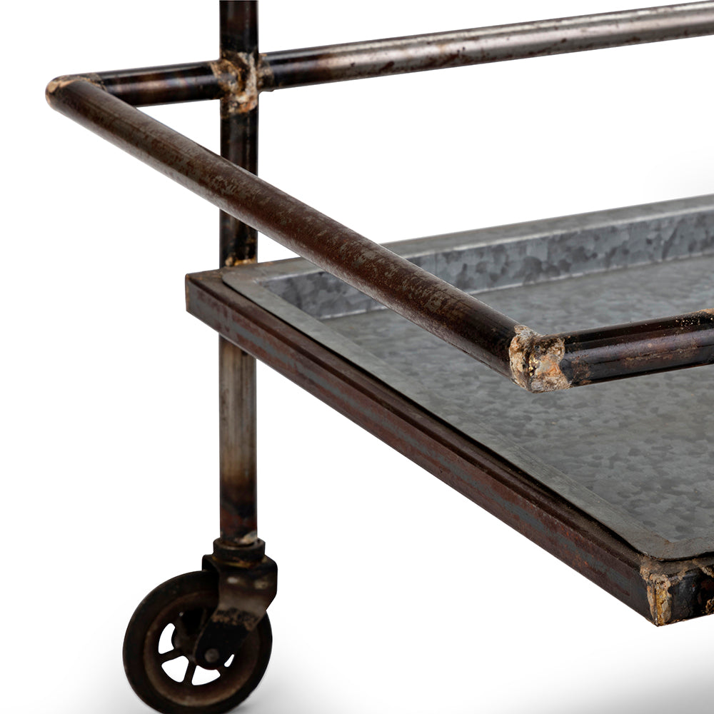 Rustic industrial metal bar cart with galvanized tray and caster wheels