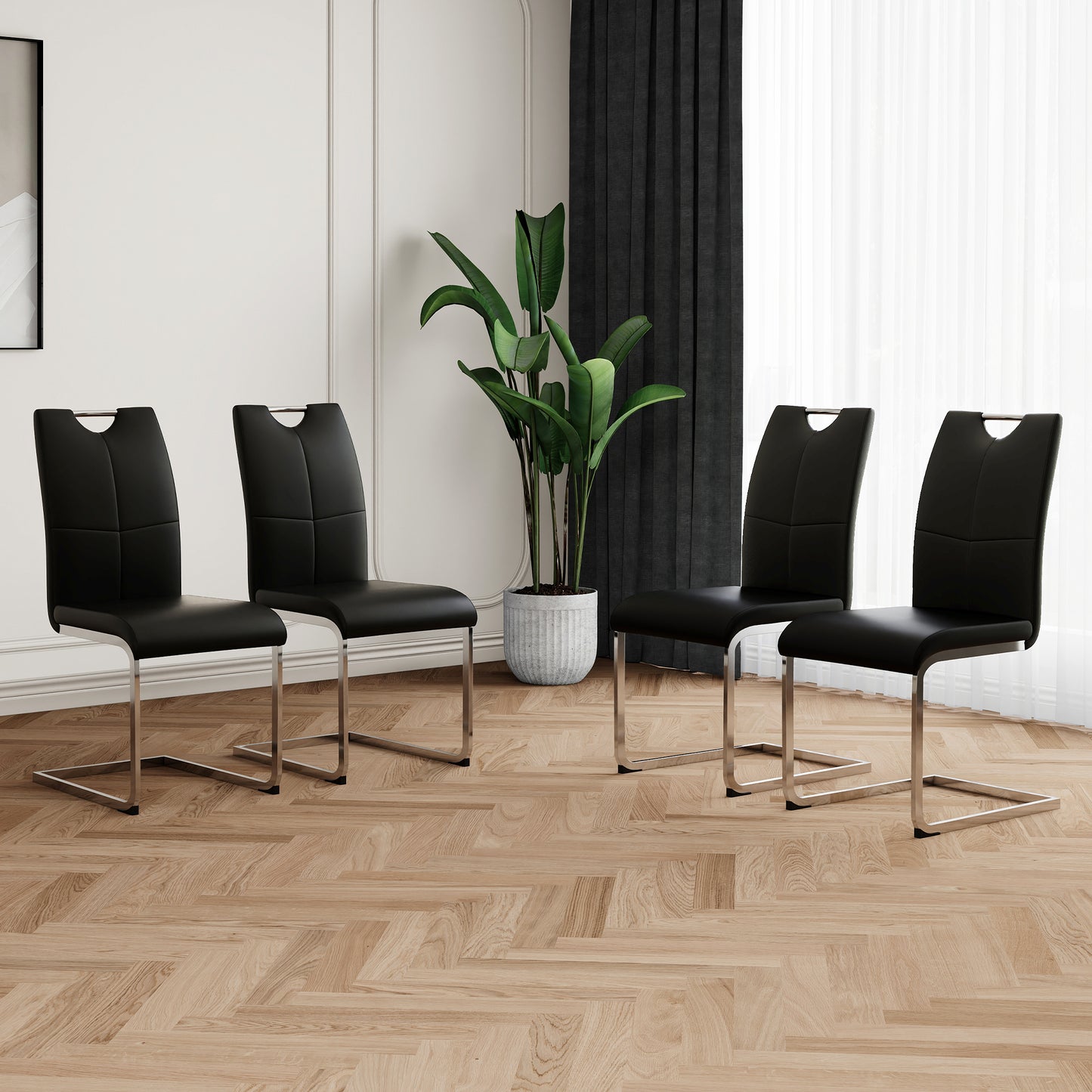Set of four black faux leather dining chairs with chrome sled legs