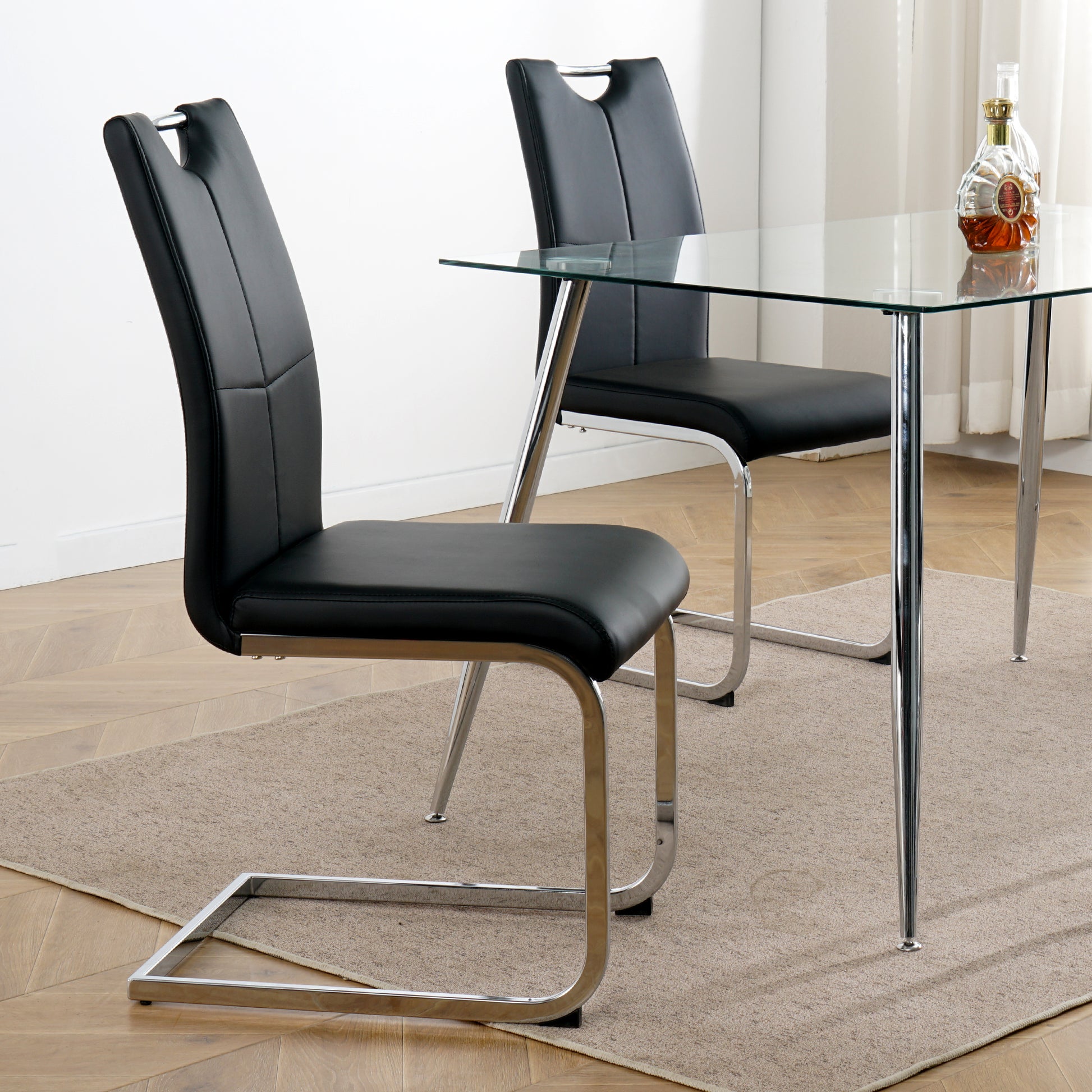 Black faux leather cantilever dining chair with chrome legs