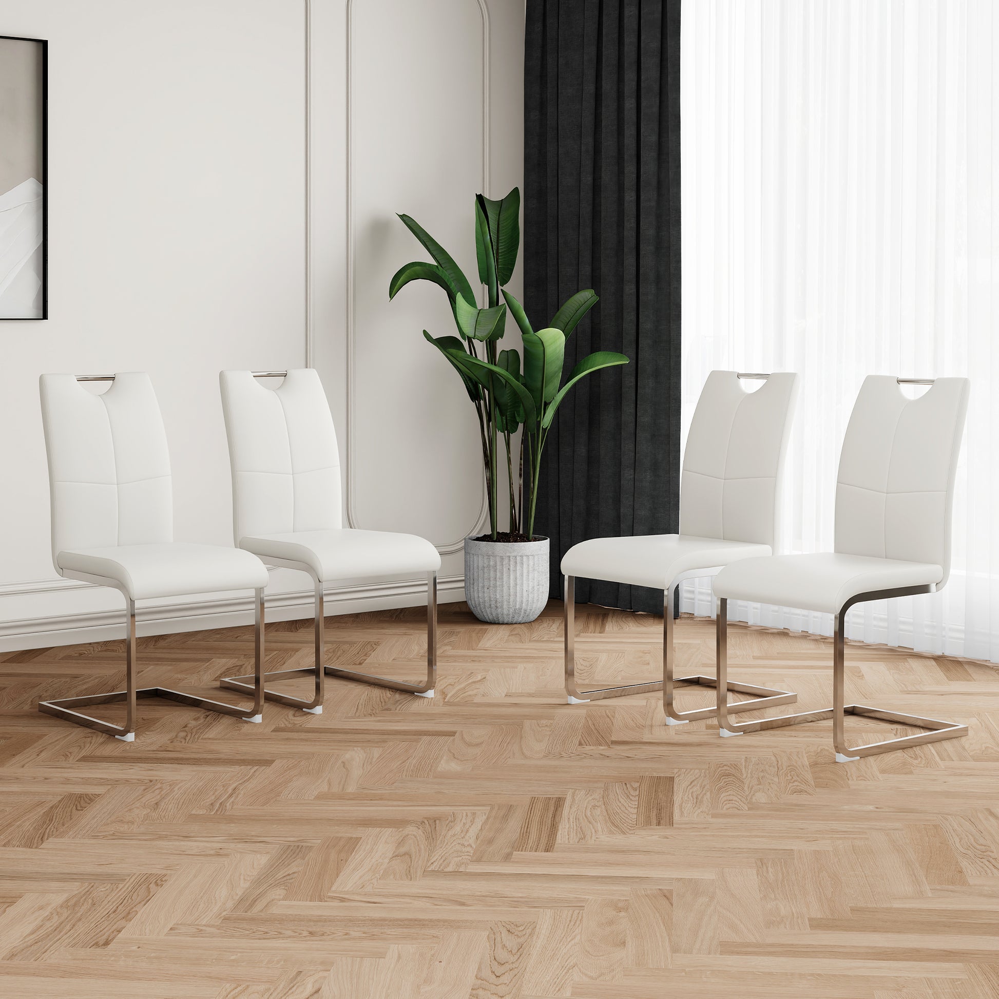 Four white faux leather dining chairs with chrome sled legs