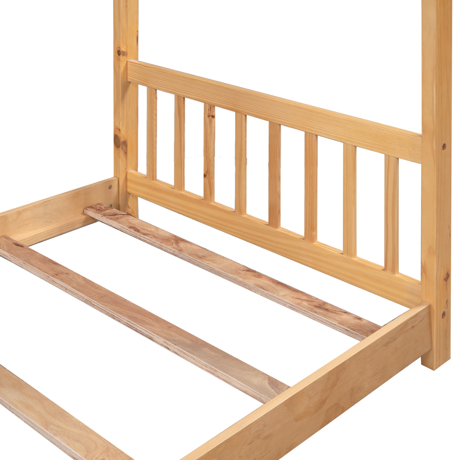 Close up of a light wood bed frame with slatted base and vertical posts