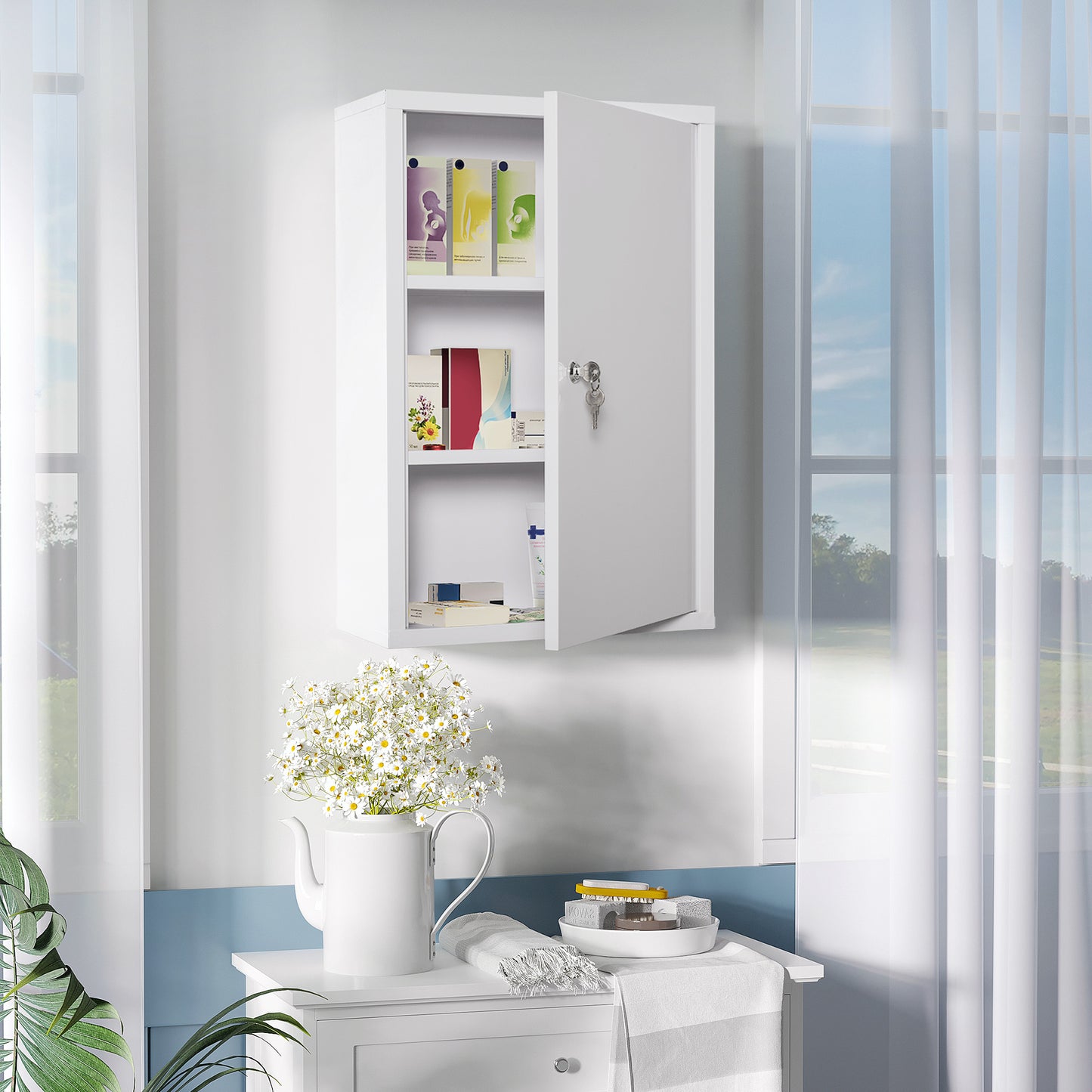 White metal wallmounted medicine cabinet with two shelves open door showing medical supplies