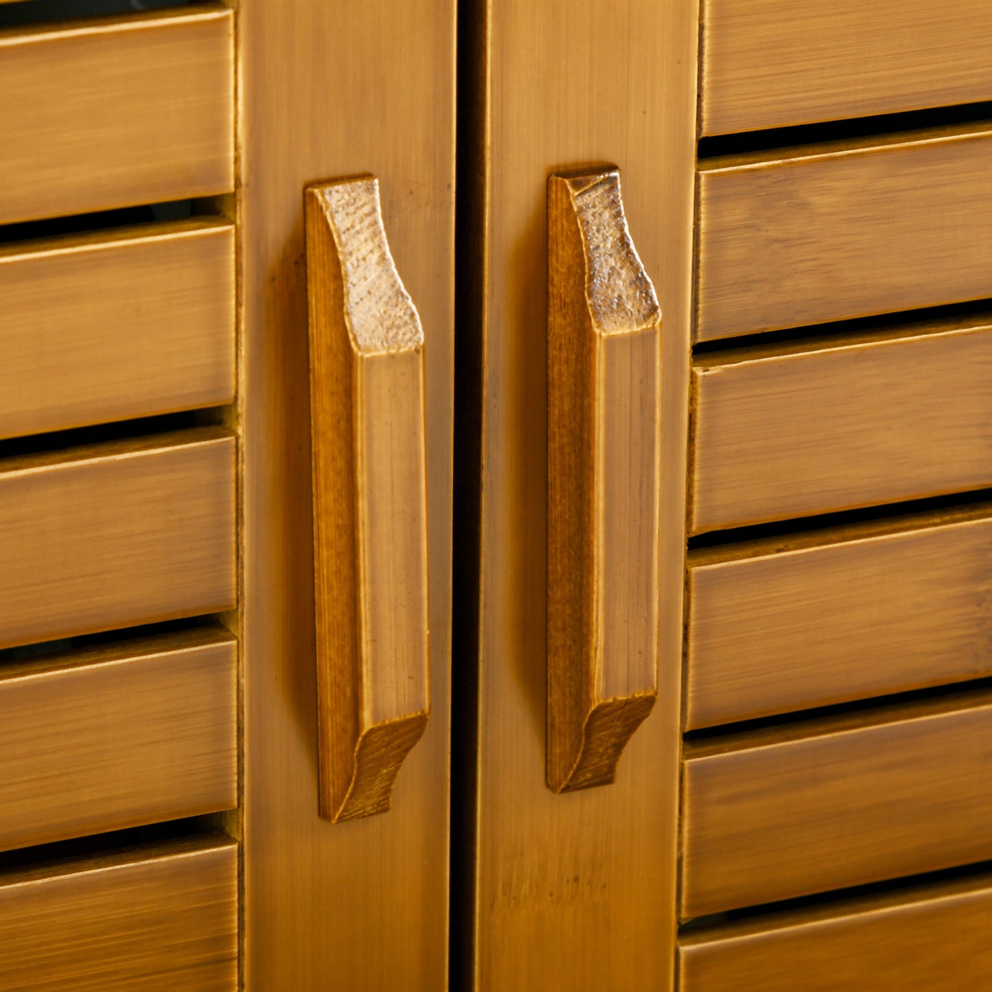 Modern brass cabinet handles on slatted doors