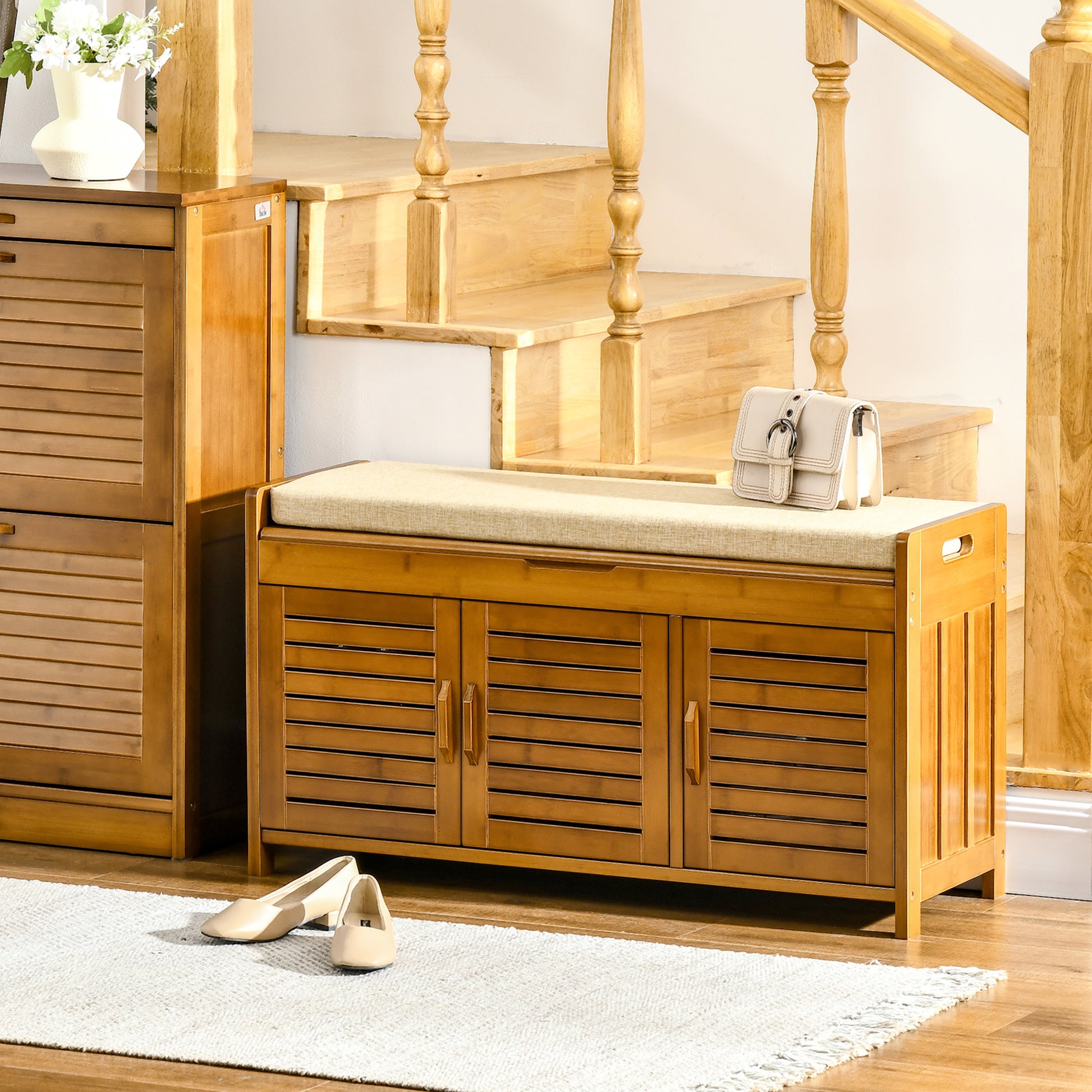 Bamboo entryway bench with three slatted doors and upholstered seat