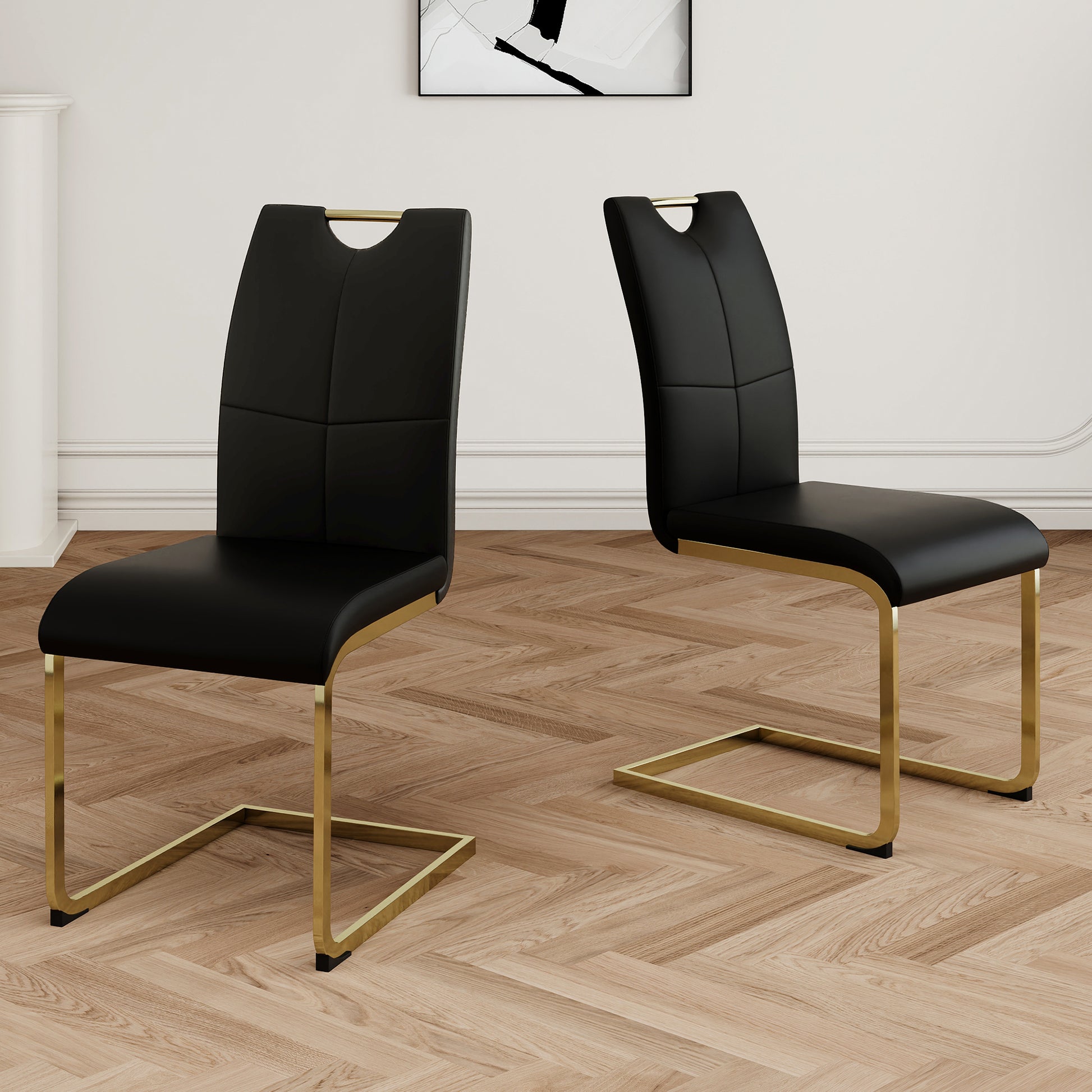 Black faux leather dining chairs with gold metal sled legs and integrated handle cutout
