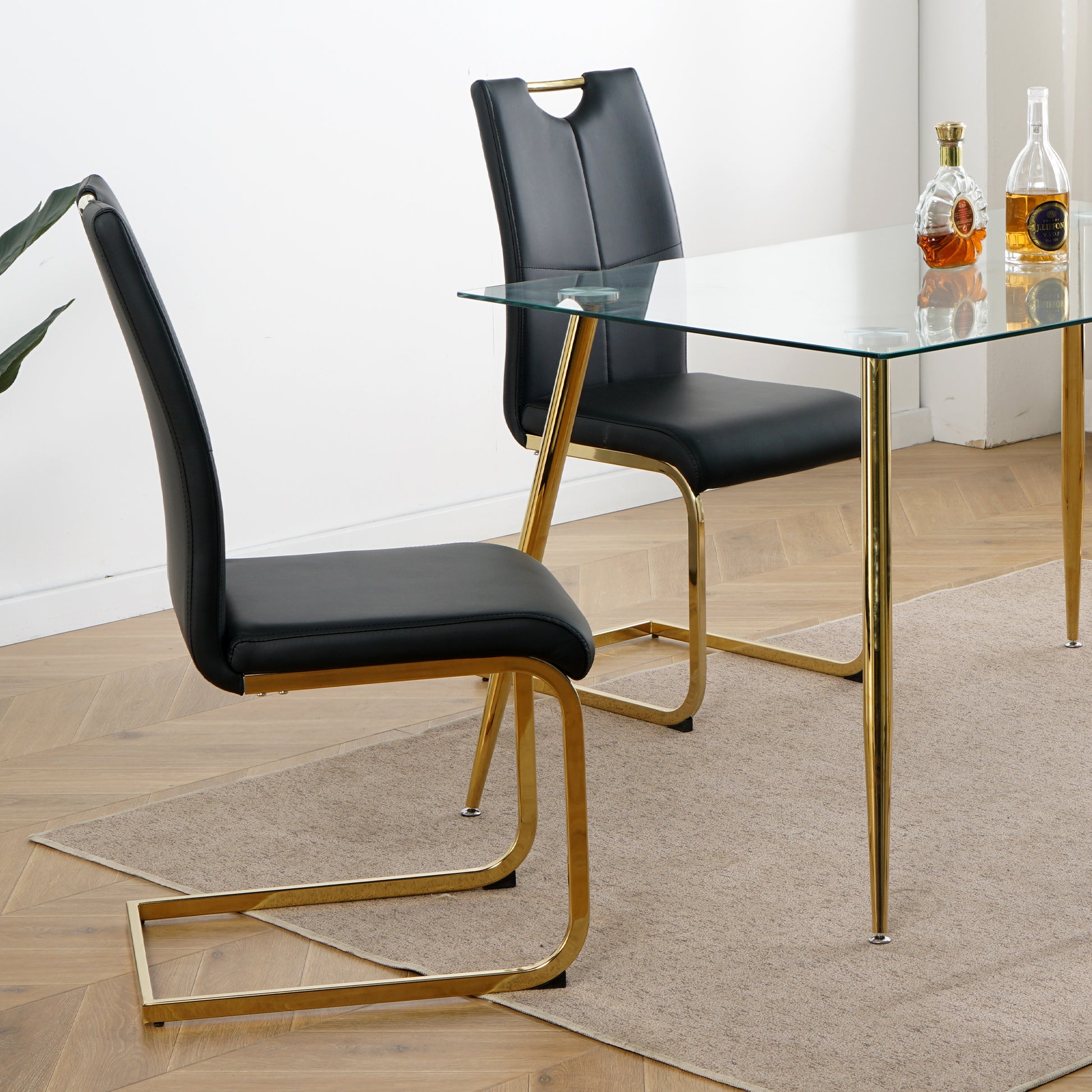 Black faux leather dining chair with gold chrome legs