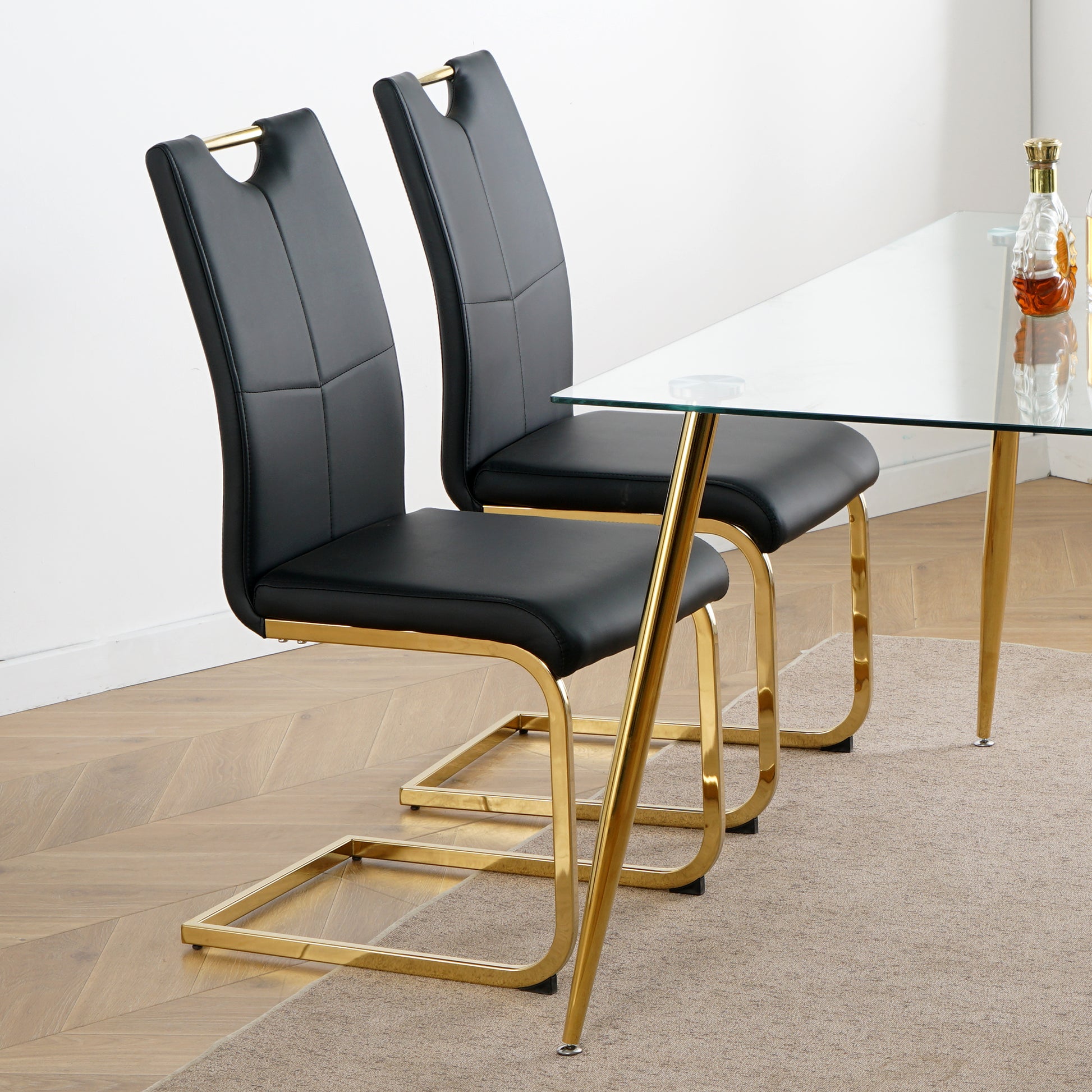 Modern black faux leather dining chair with gold sled base