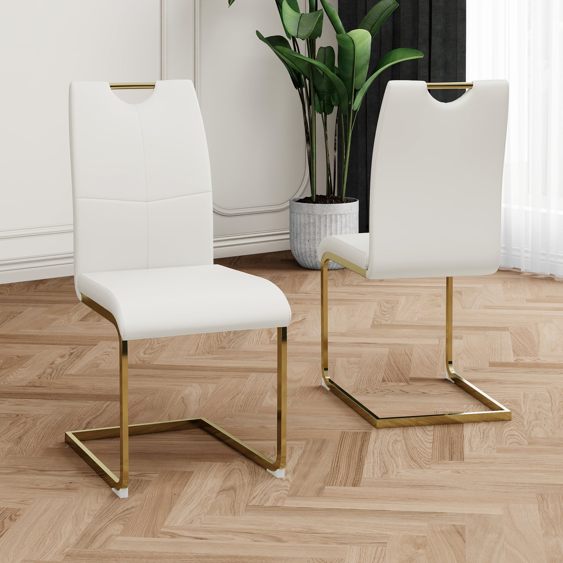 White faux leather dining chair with gold sled legs and cutout handle