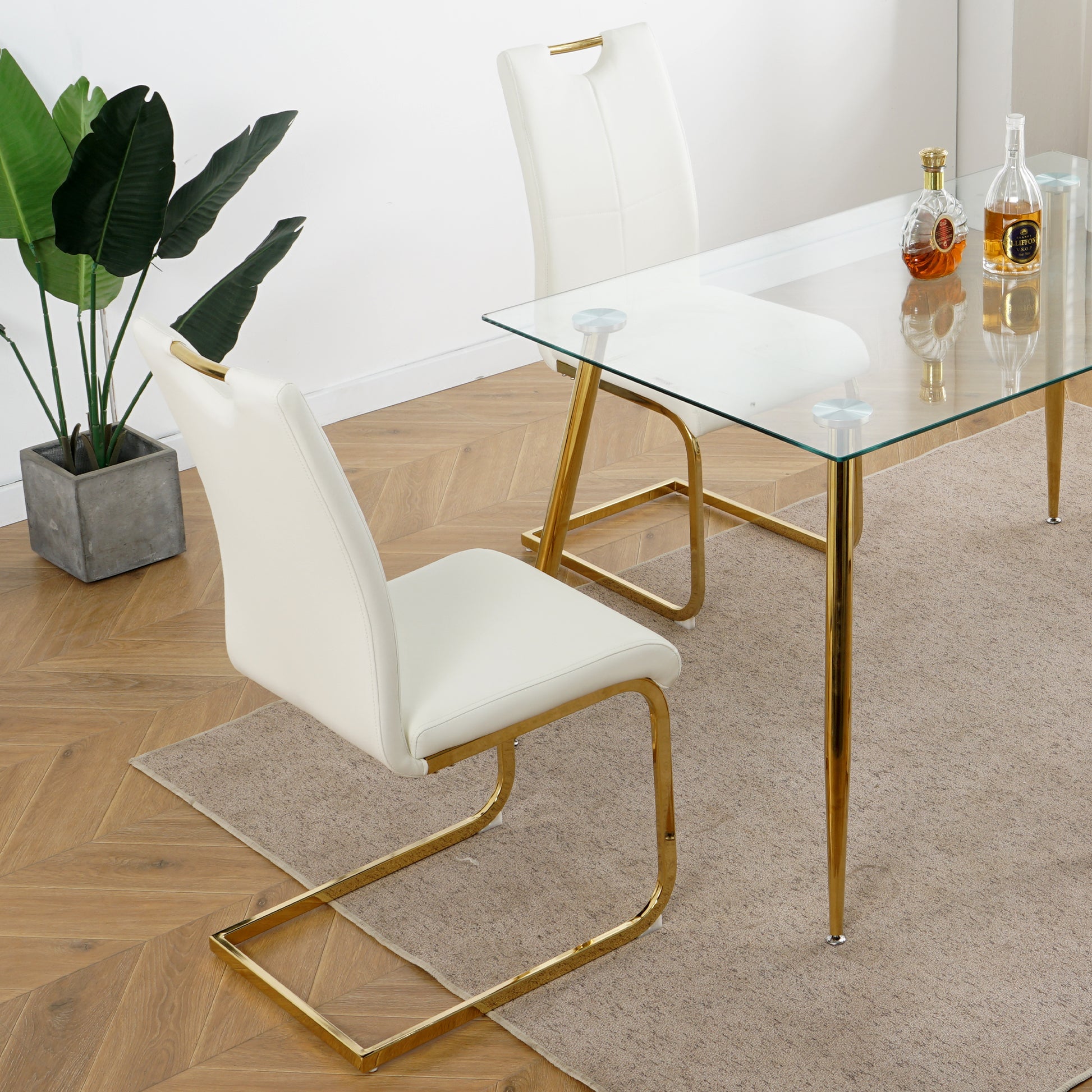 White faux leather dining chair with gold sled base and top accent