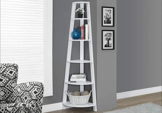 White wooden corner shelf unit displaying decorative items and books