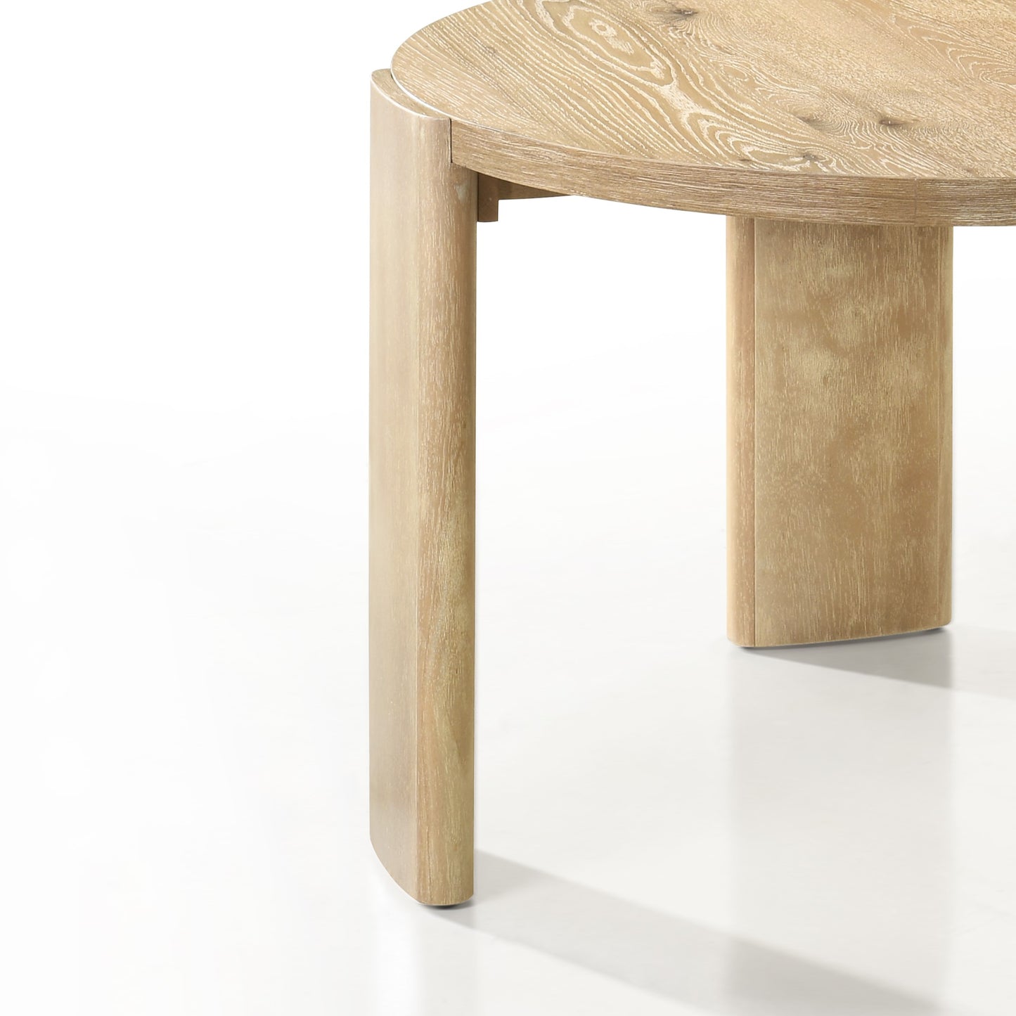 Closeup of a light wood round dining table with visible grain