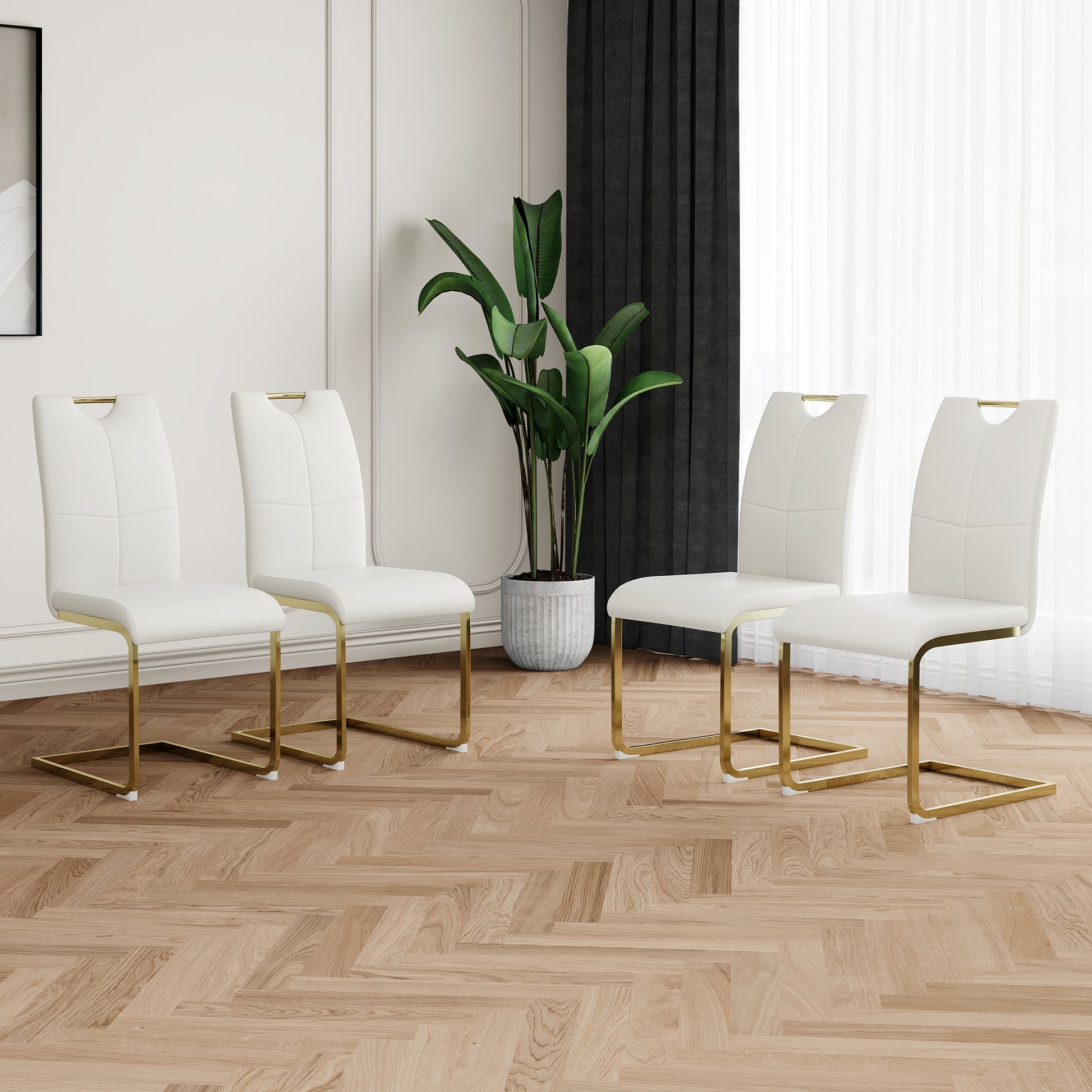 Set of four white faux leather dining chairs with gold metal legs