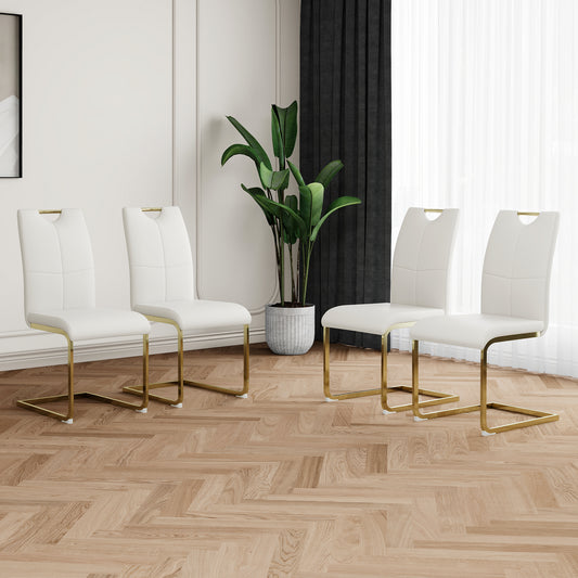 Set of four white faux leather dining chairs with gold metal legs