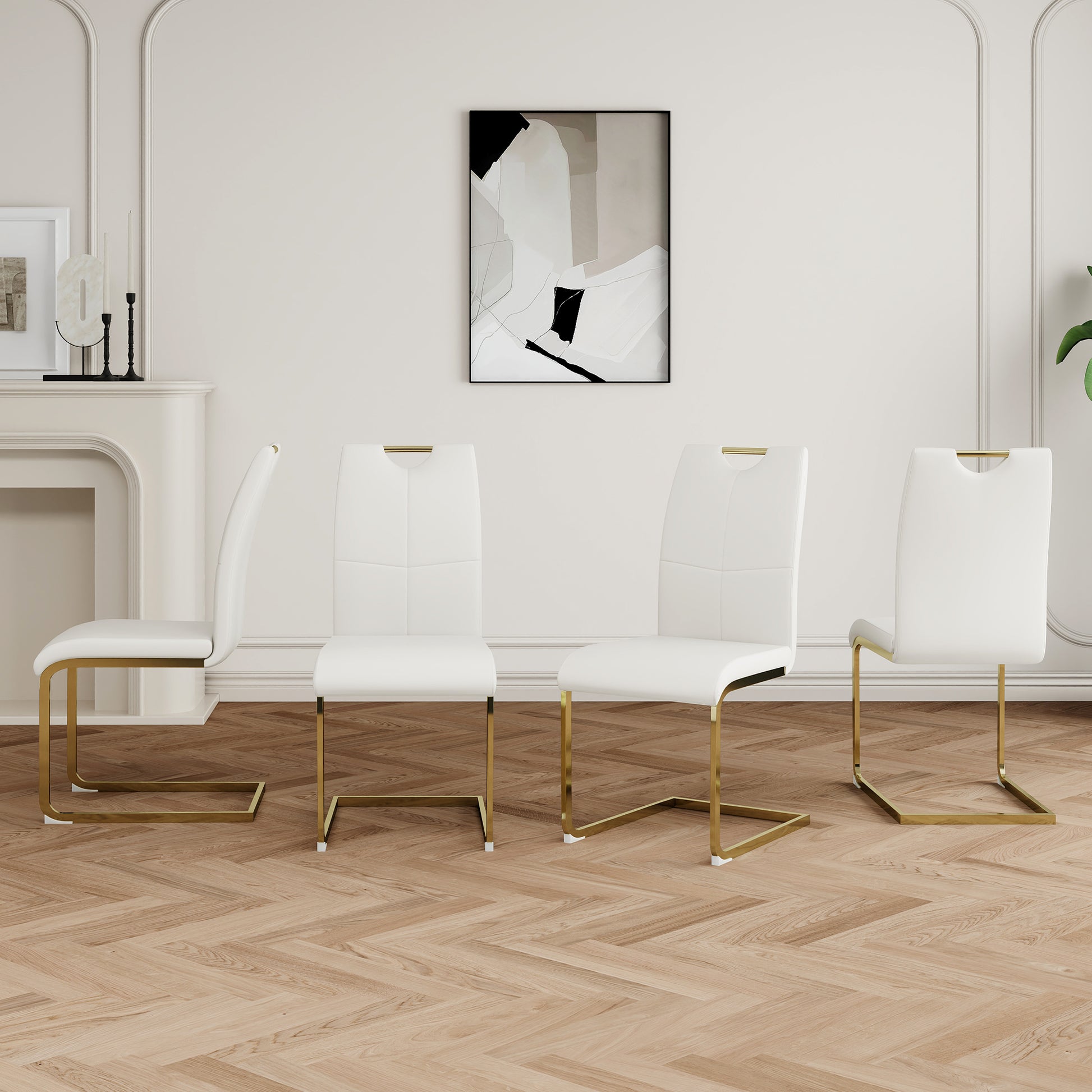 Four white faux leather dining chairs with gold metal legs