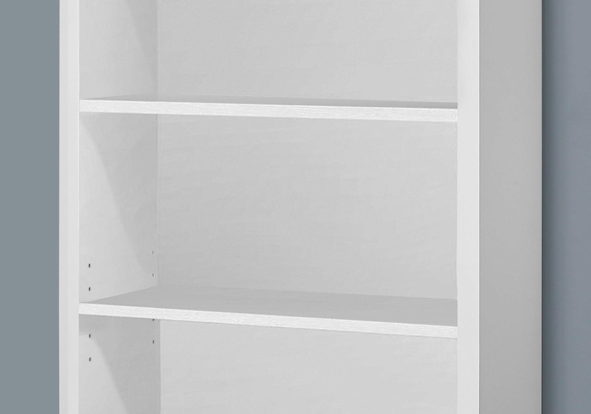 Modern white particle board bookshelf with three shelves for storage